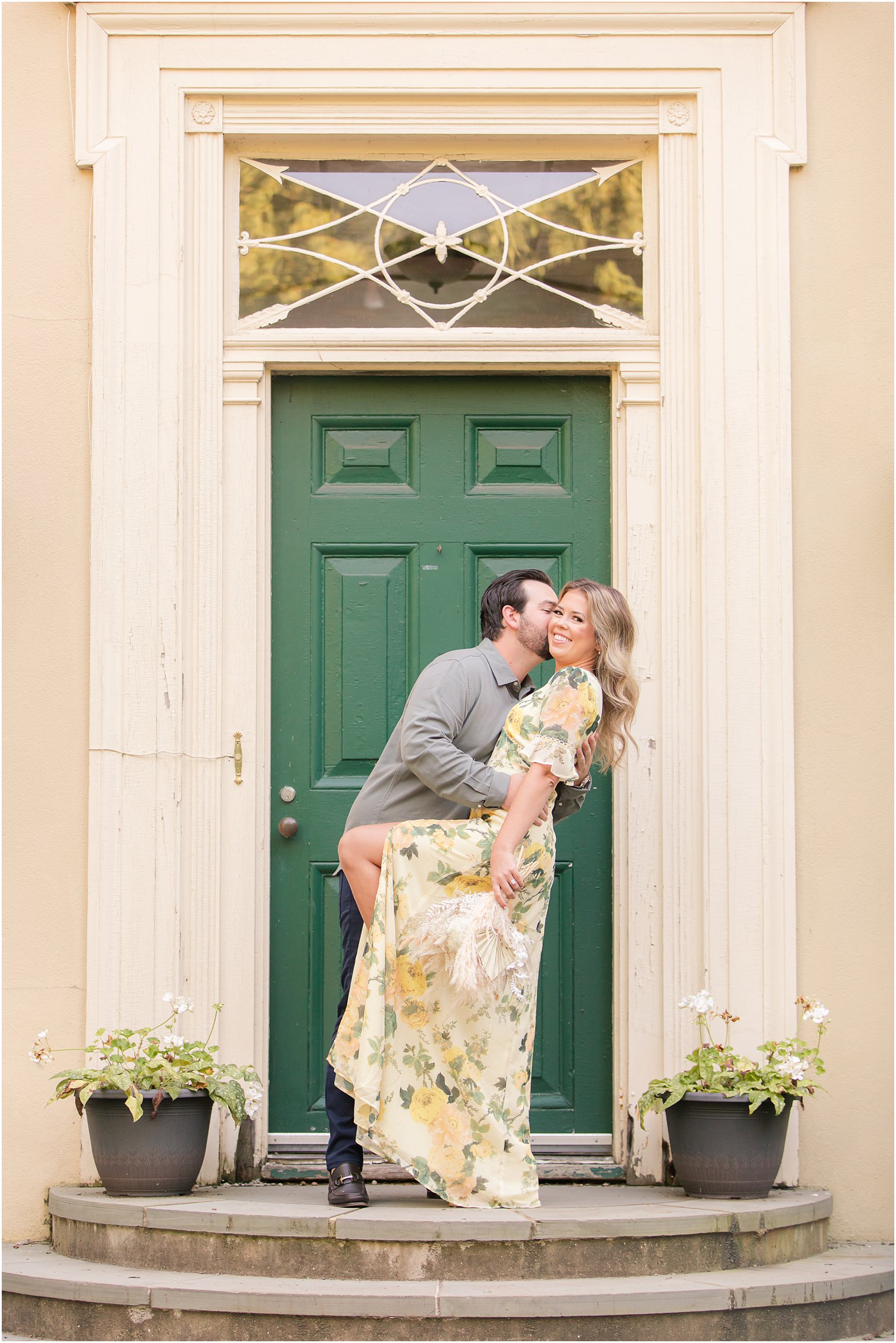 groom kisses bride on the cheek during summer engagement photos