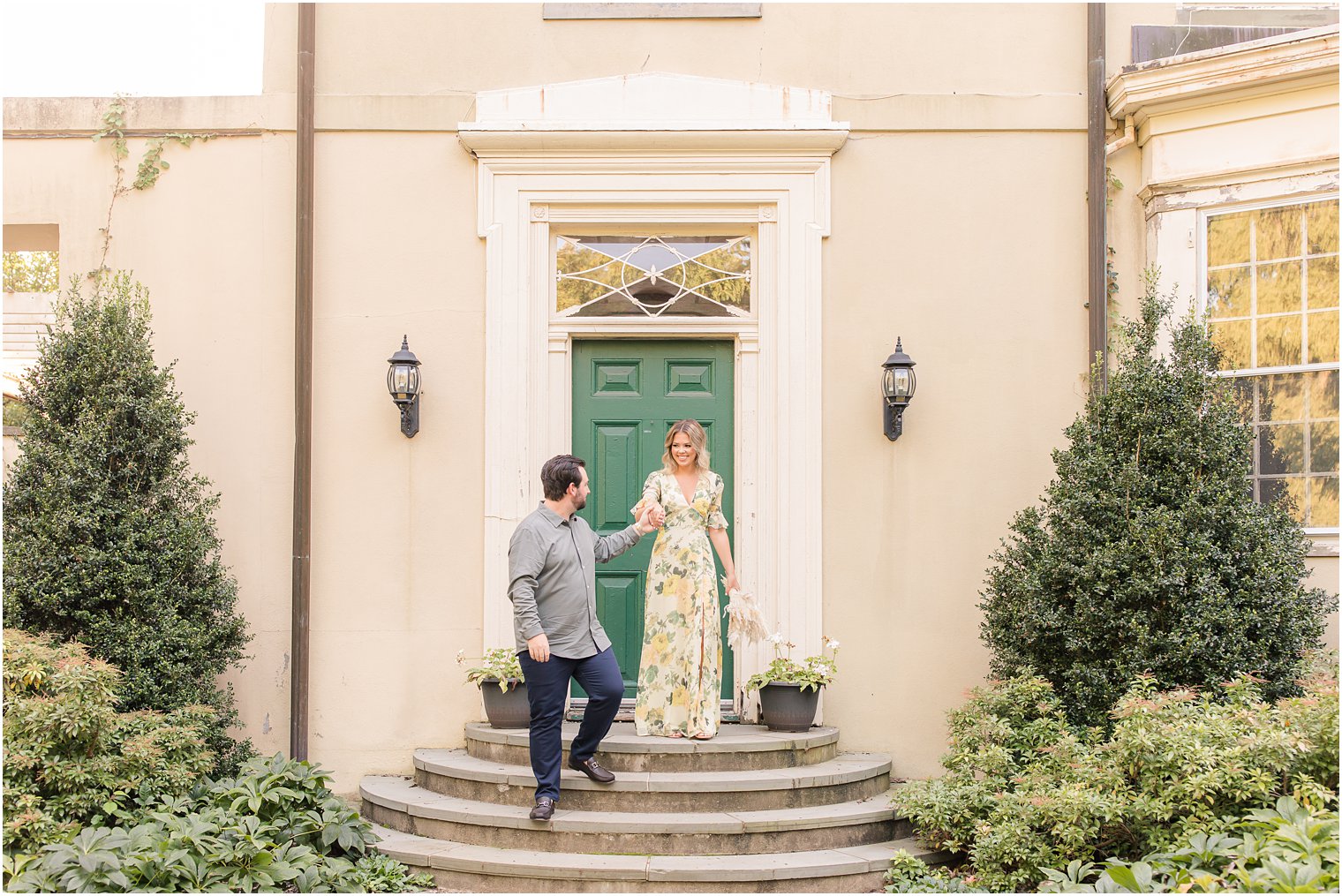 groom helps bride down steps at Cross Estate Gardens
