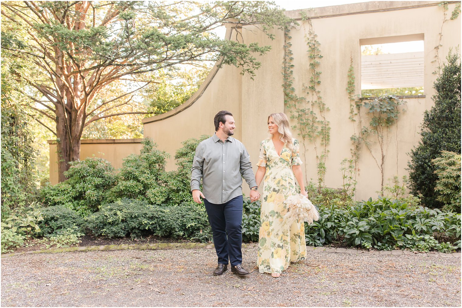 bride and groom walk near entrance of Cross Estate Gardens