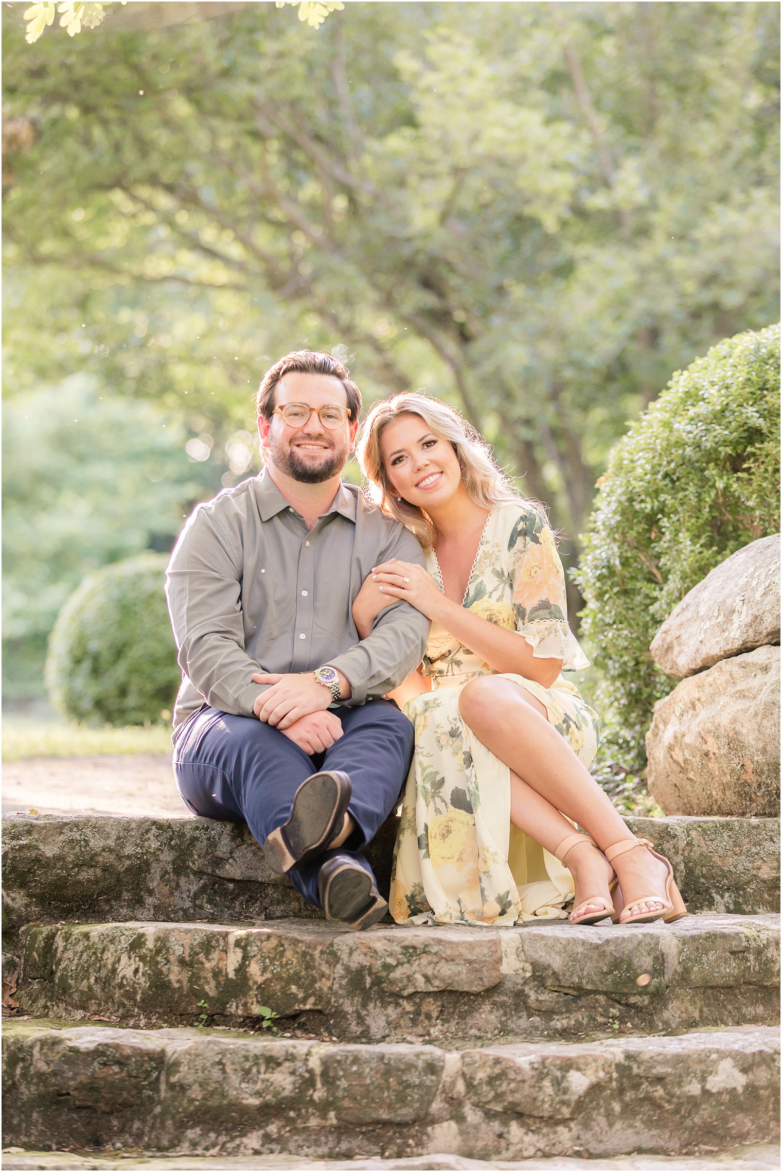 bride and groom sit on steps at Cross Estate Gardens