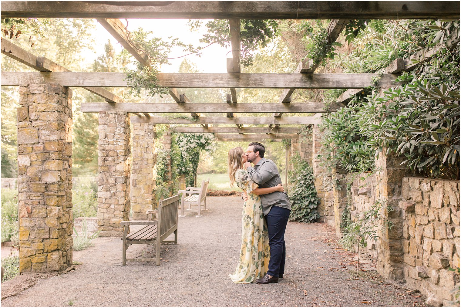 bride and groom kiss under pergola at Cross Estate Gardens