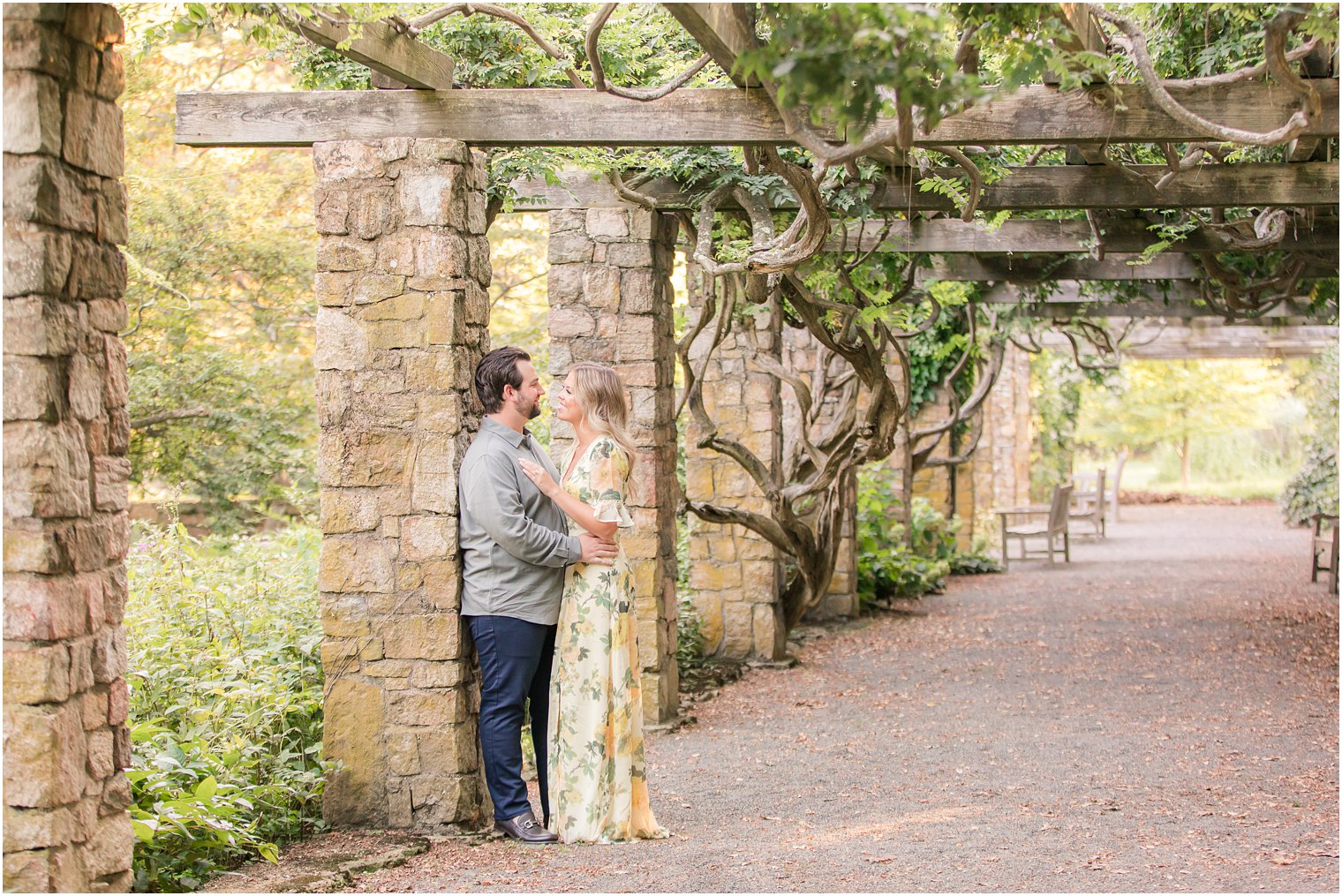 bride and groom pose by pergola posts in New Jersey