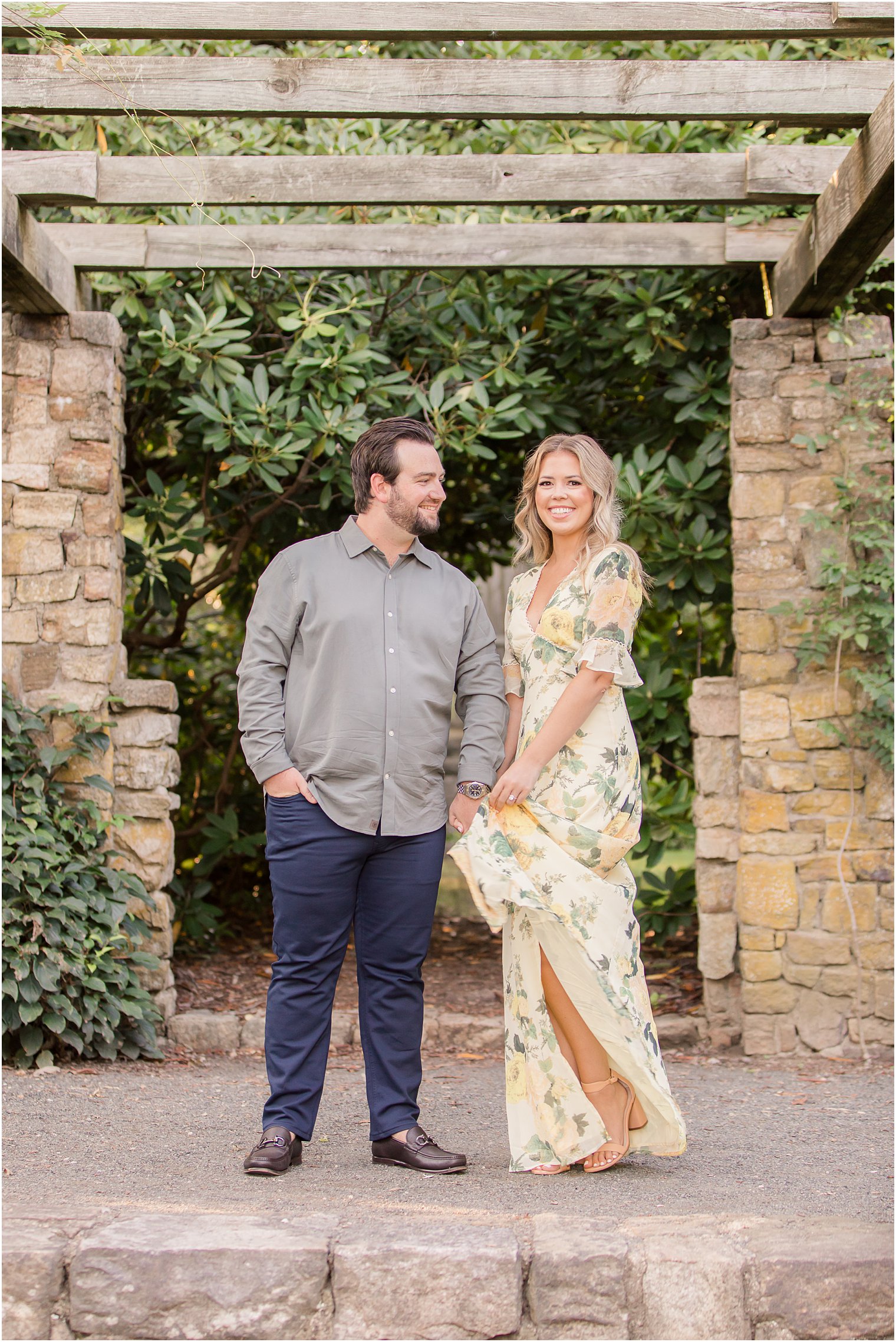 bride twirls yellow floral dress during engagement photos