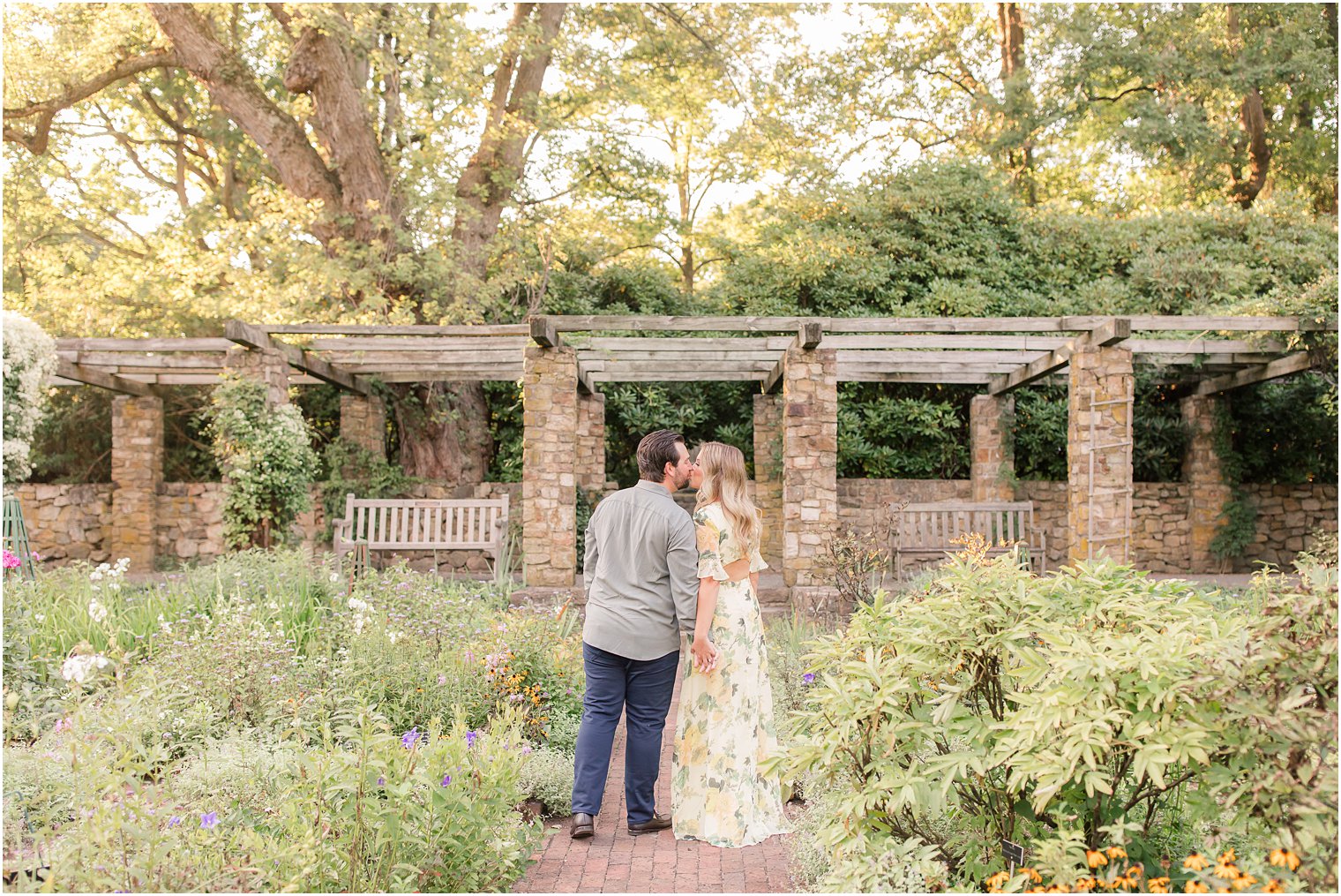 bride and groom kiss in gardens at Cross Estate Gardens