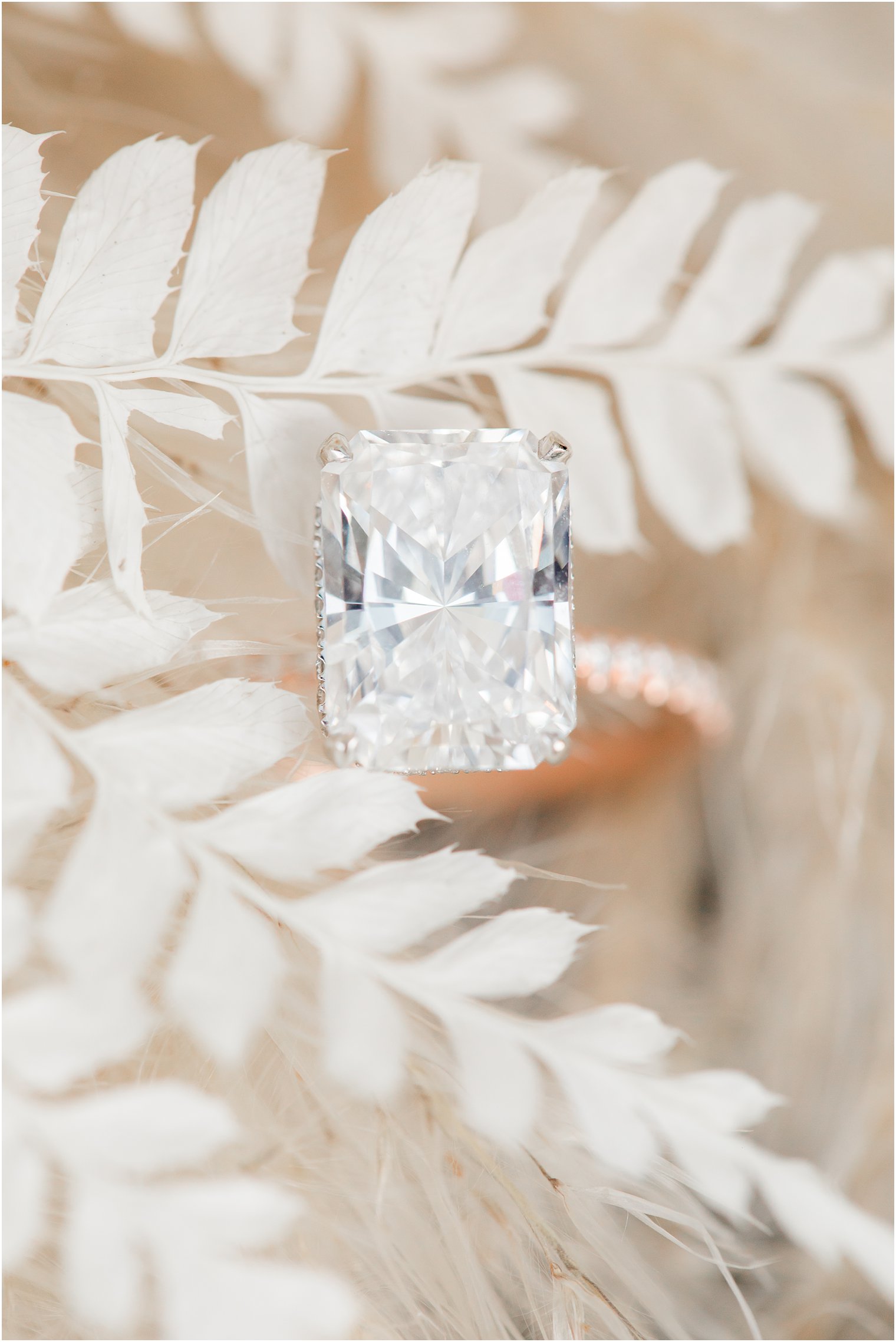 rectangular diamond ring sits on white flowers
