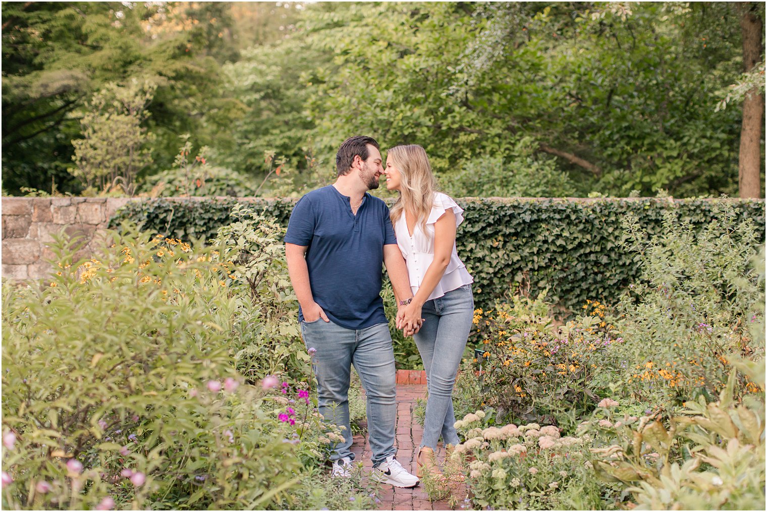 bride and groom stand nose to nose during NJ engagement photos