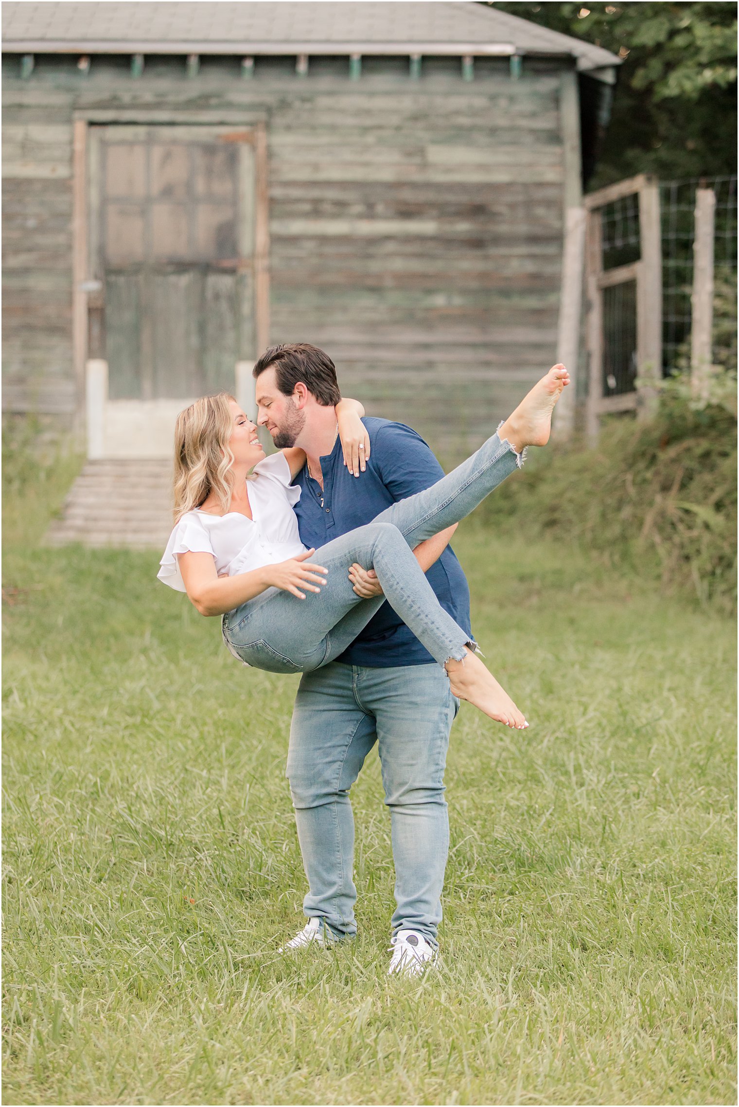 groom lifts bride during engagement photos in New Jersey