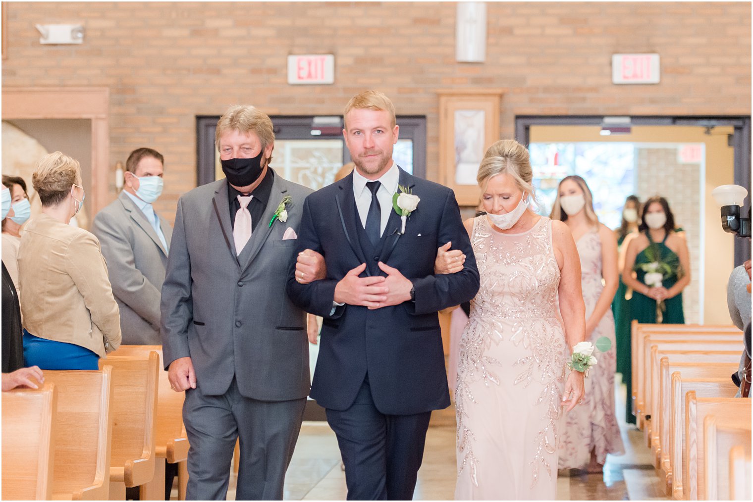 groom walks parents down aisle at traditional Toms River NJ church wedding