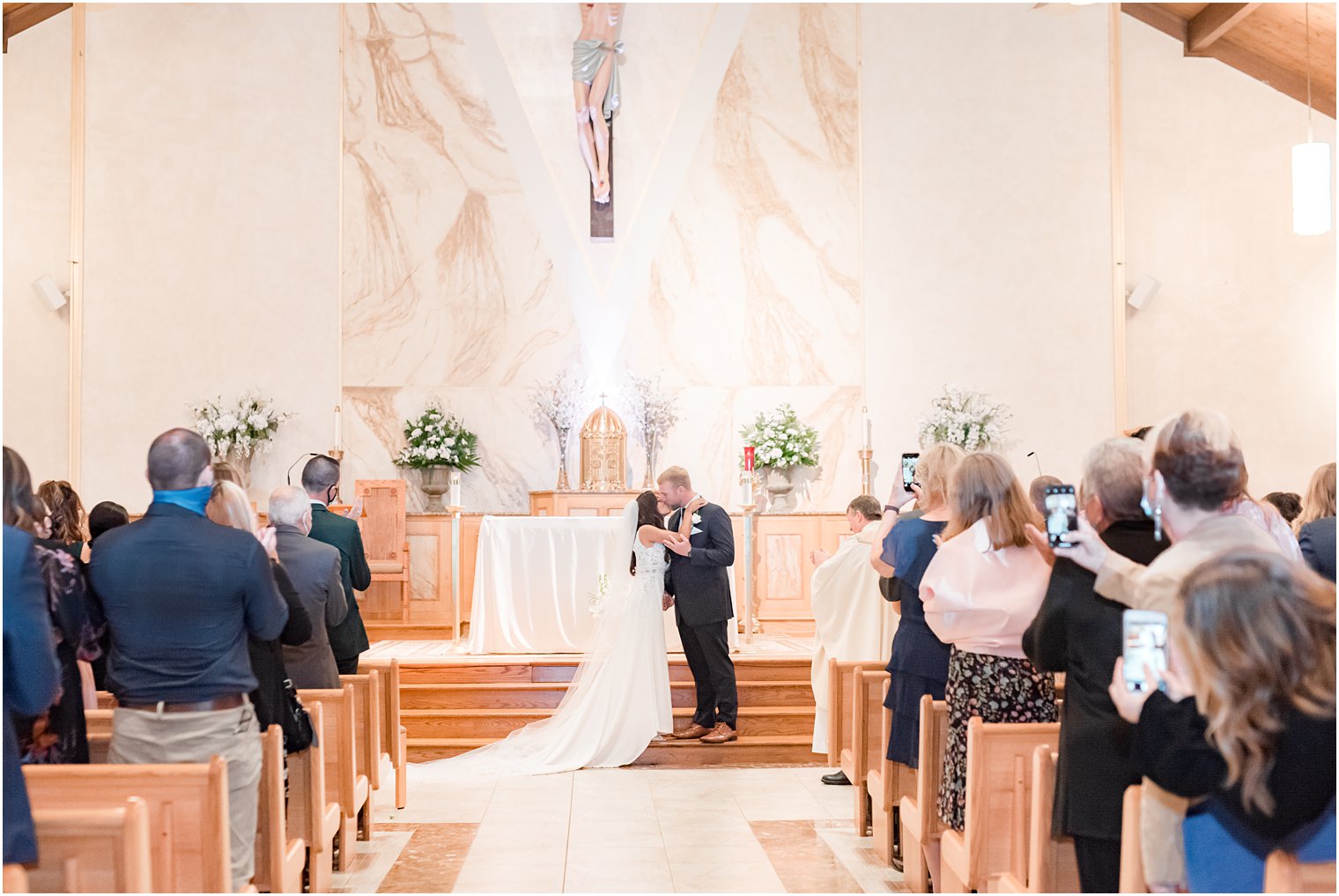 bride and groom kiss during traditional Toms River NJ church wedding