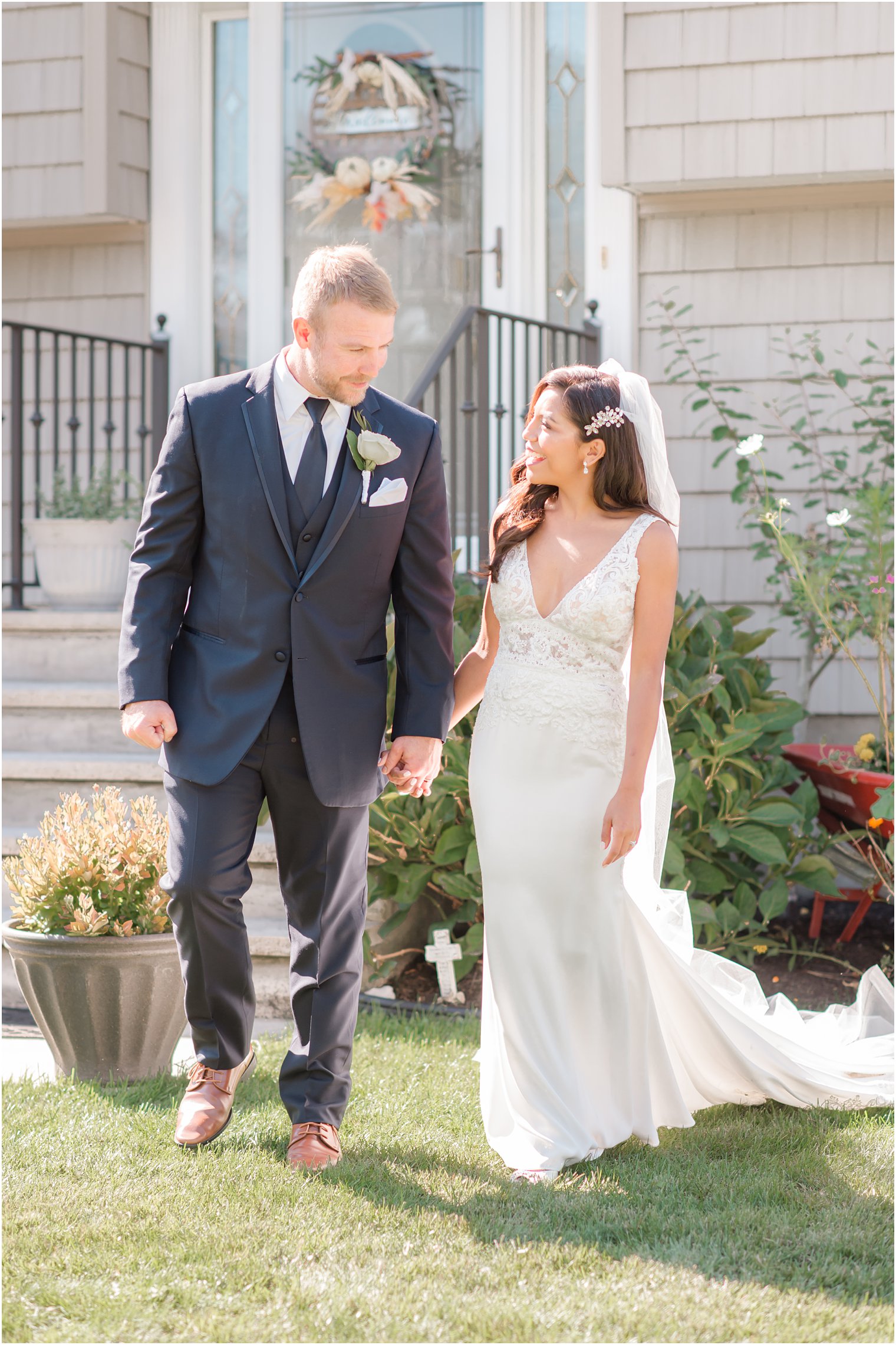 bride and groom walk together after Tom's River backyard wedding