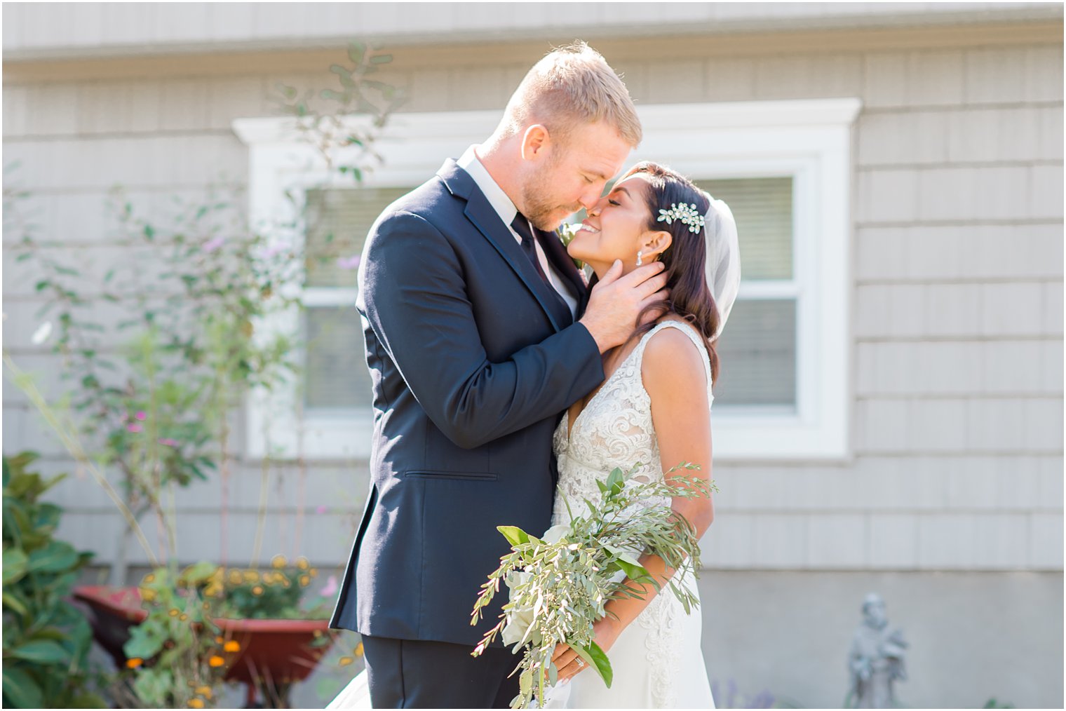 groom kisses bride during New Jersey wedding portraits