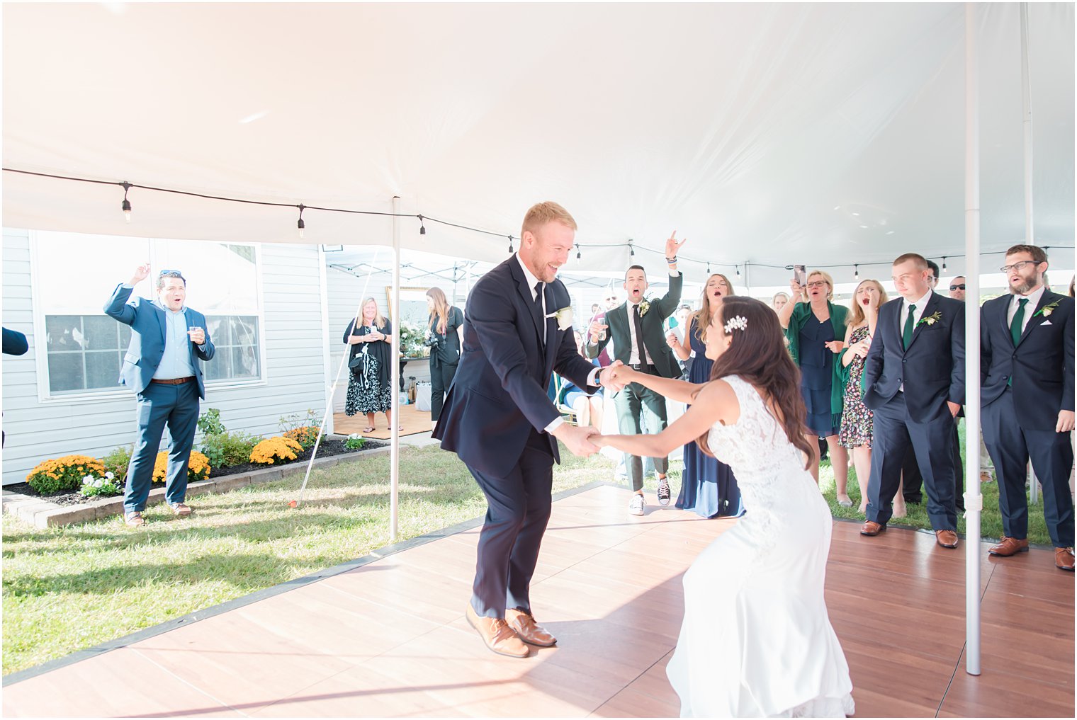bride and groom dance under tent at wedding reception