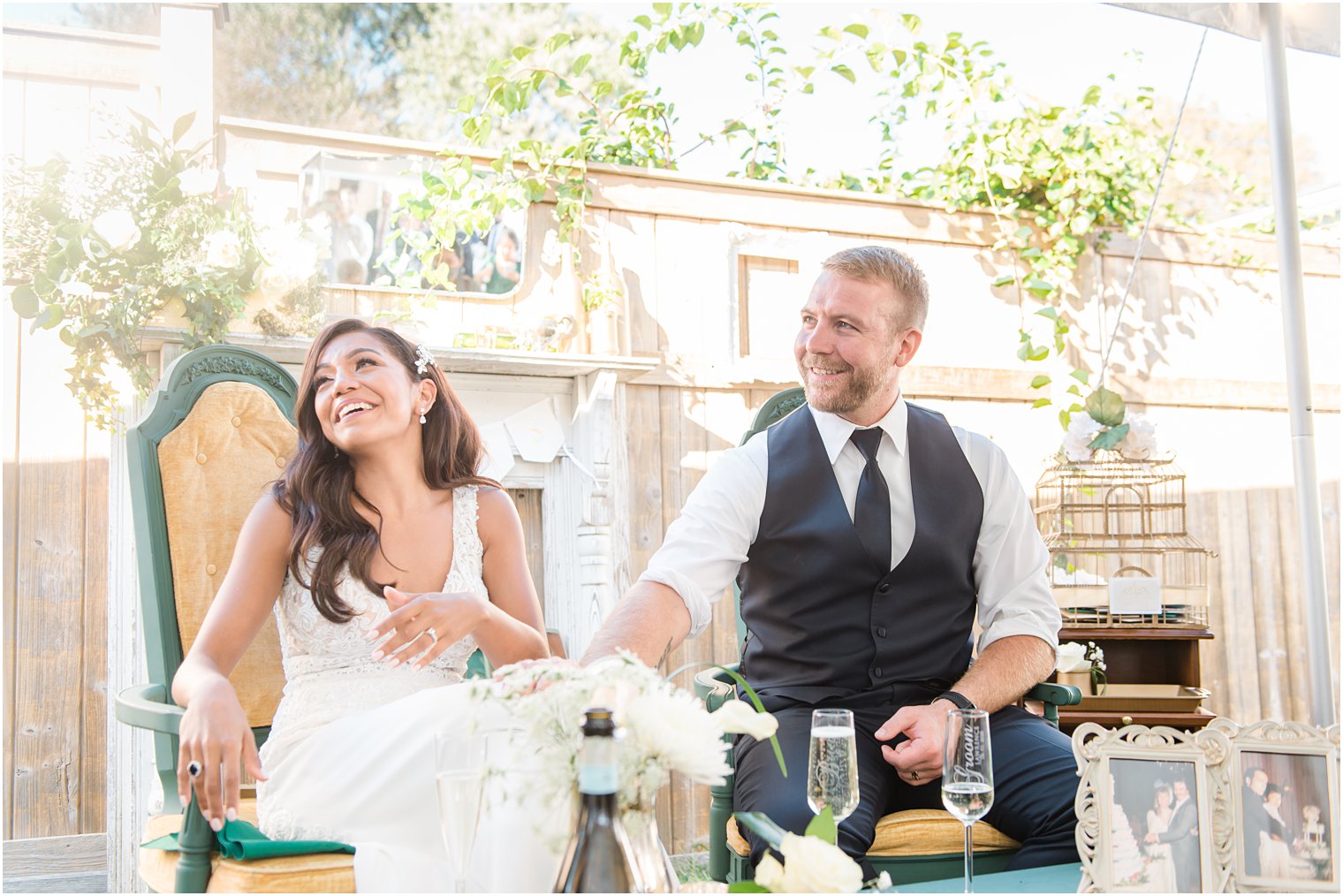 newlyweds laugh during wedding reception toasts