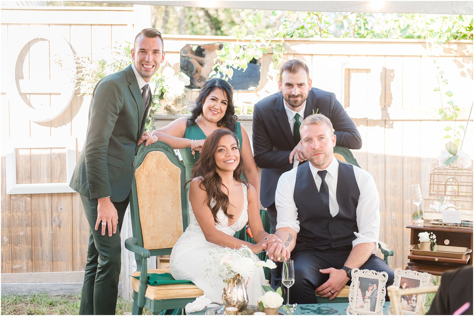 bride and groom pose with best man, maid of honor, and man of honor