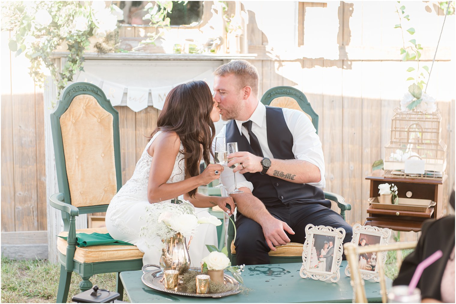 bride and groom kiss during toasts 