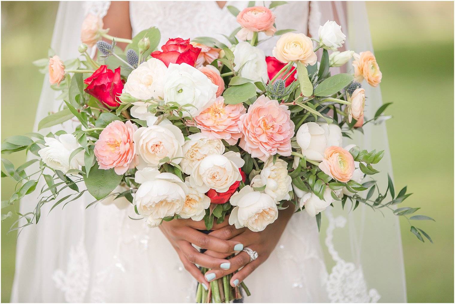 bride holds bouquet with pink and ivory flowers by Bespoke Floral and Event Design