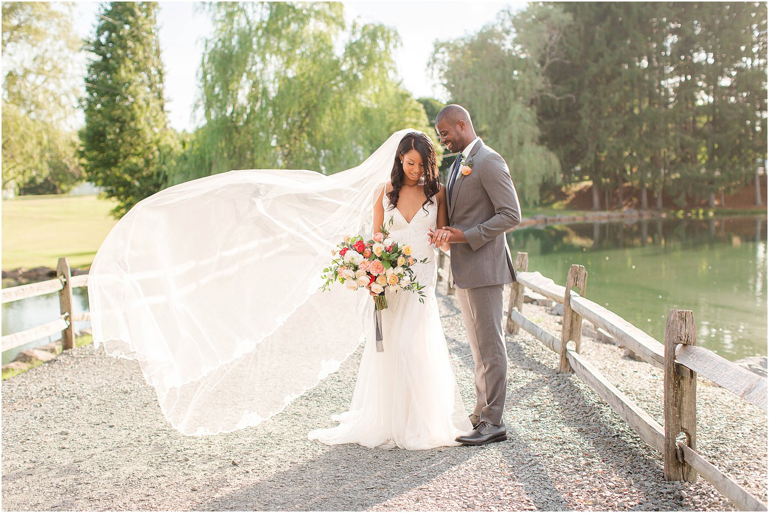 fall wedding portraits with bride's veil in the wind