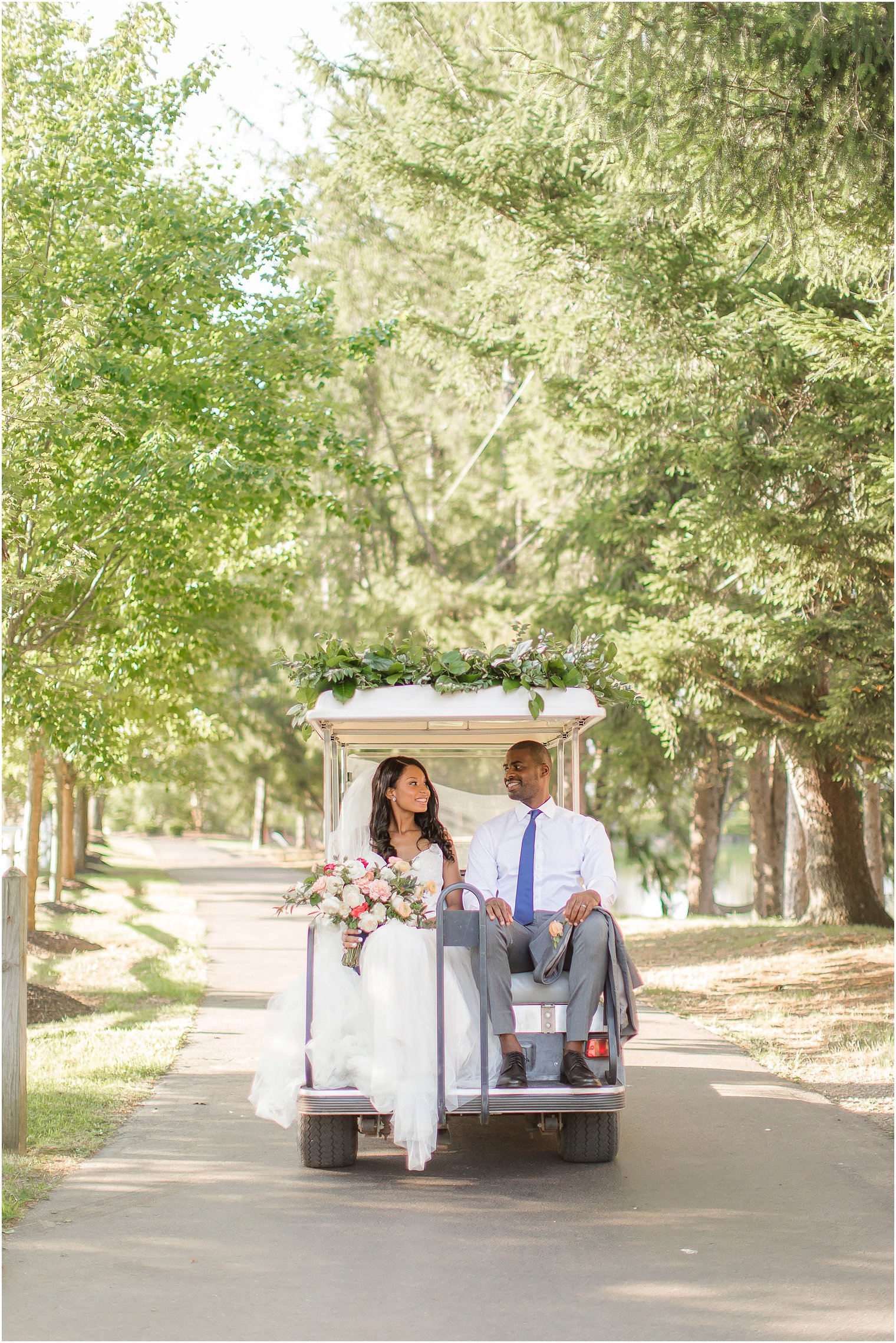 bride and groom ride on golf cart at Windows on the Water at Frogbridge