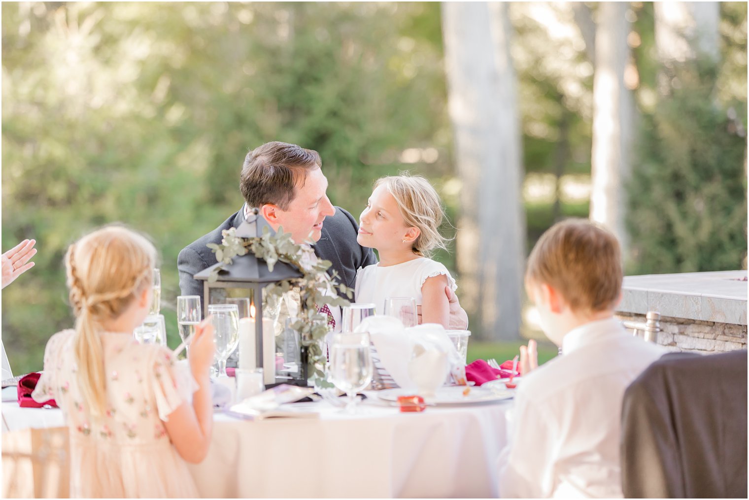 groom sits with kids at Indian Trail Club Micro Wedding reception
