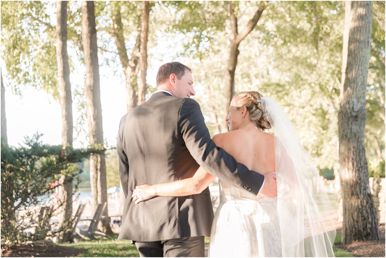 newlyweds walk along trail at Indian Trail Club