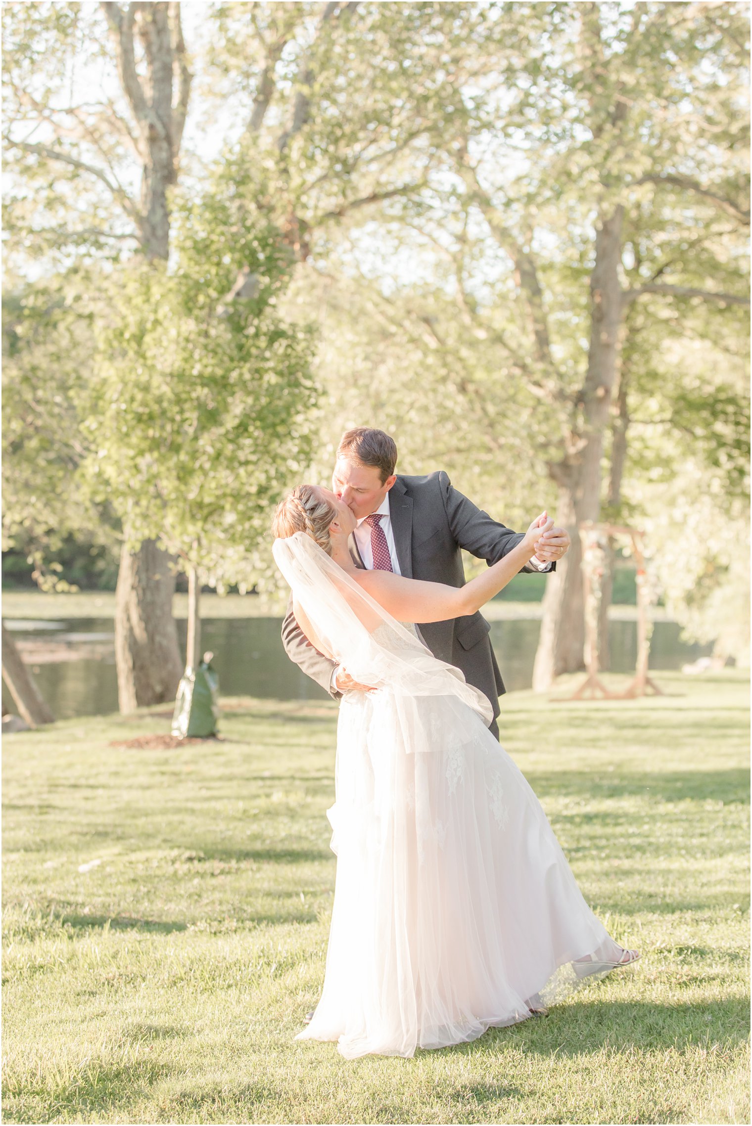 newlyweds dance and kiss during portraits at Indian Trail Club