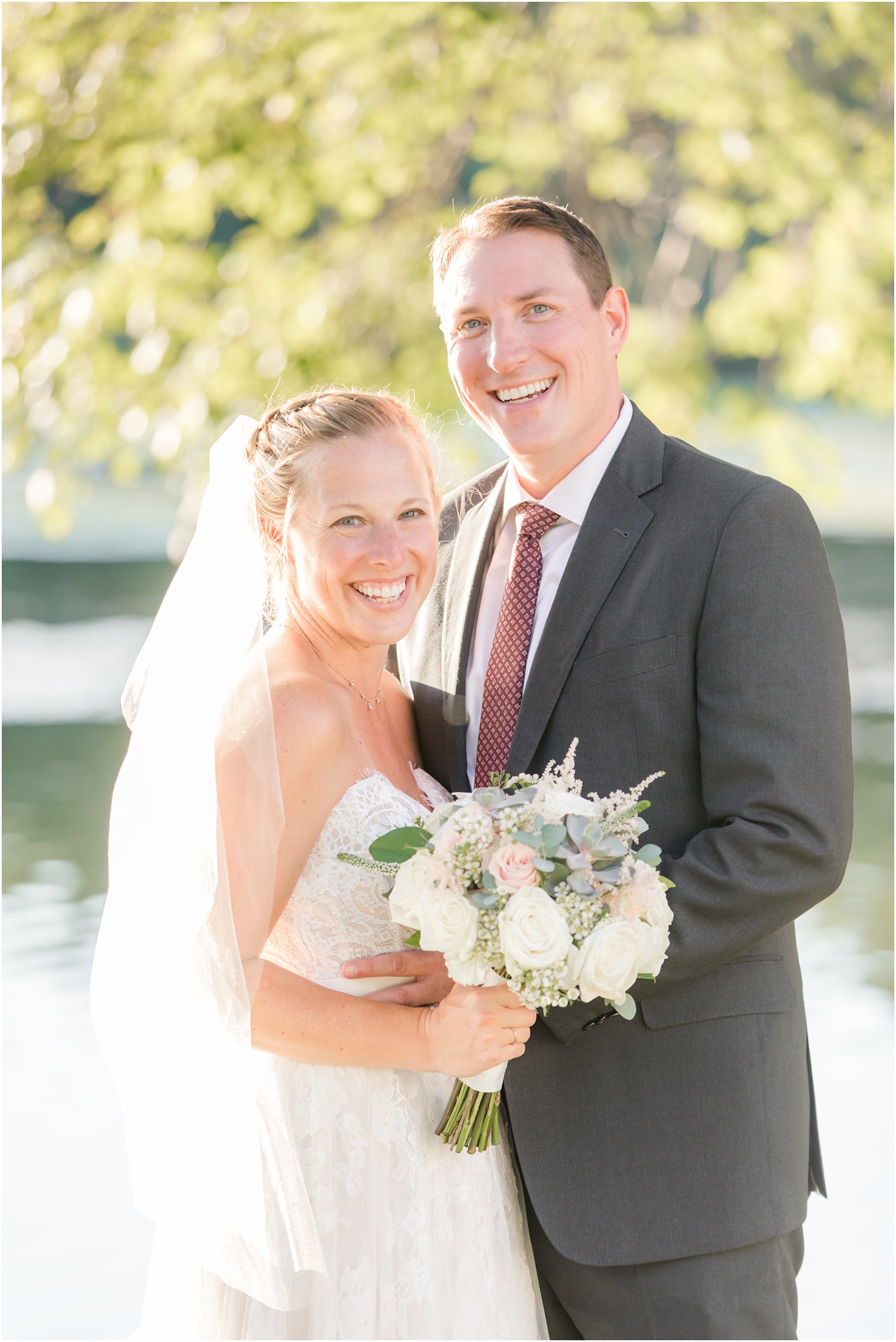 bride and groom laugh during wedding portraits in Franklin Lakes NJ