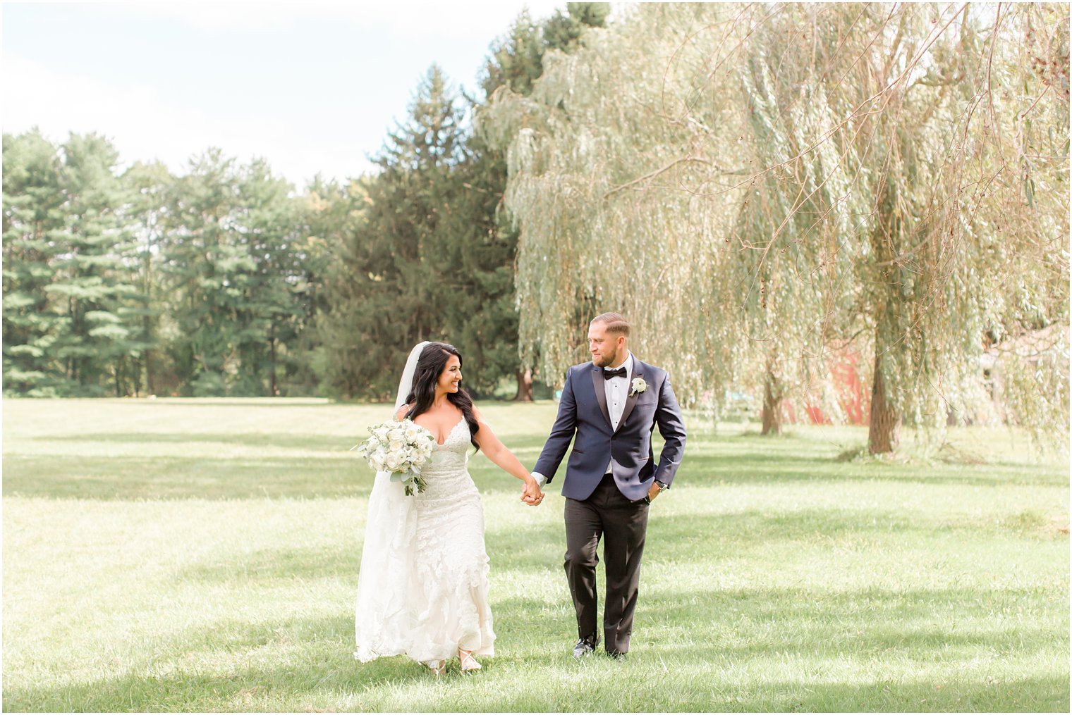 bride and groom hold hands walking during Millstone NJ wedding photos