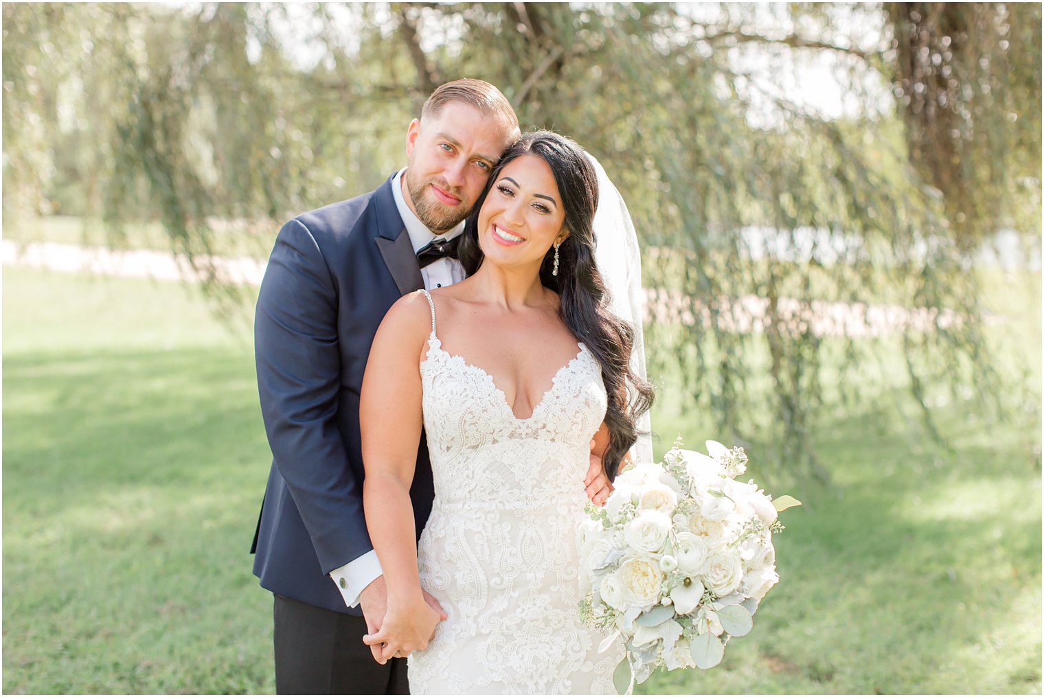 bride and groom lean heads together during NJ wedding photos