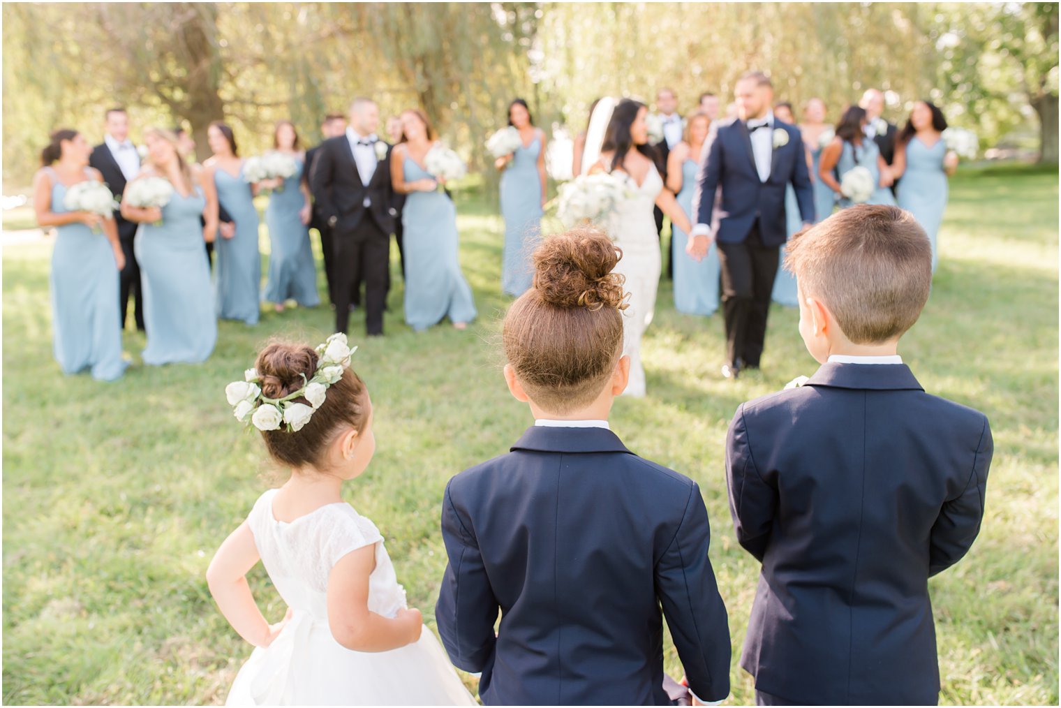 children watch bridal party walk during portraits at Windows on the Water at Frogbridge