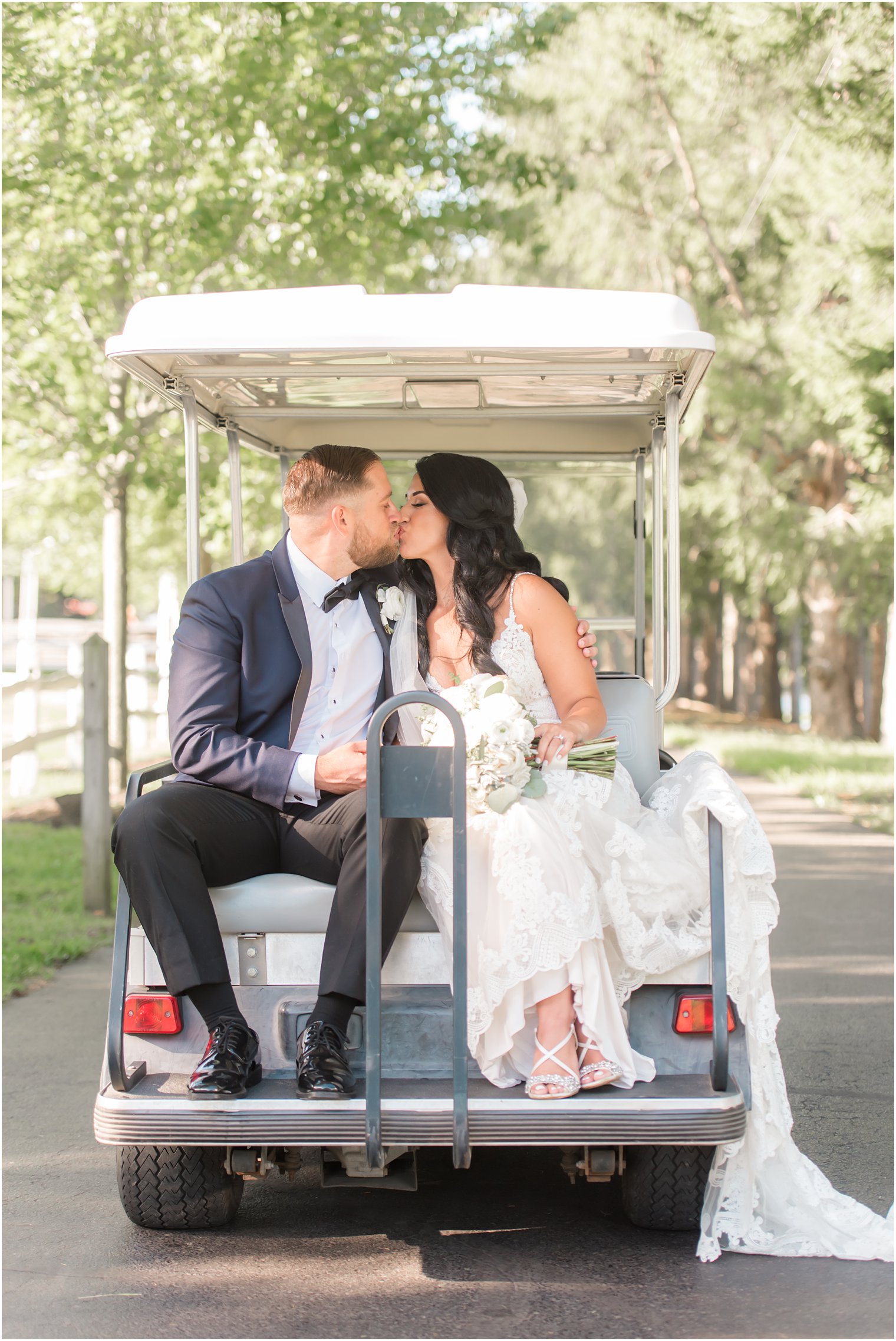 bride and groom ride on golf cart at Windows on the Water at Frogbridge