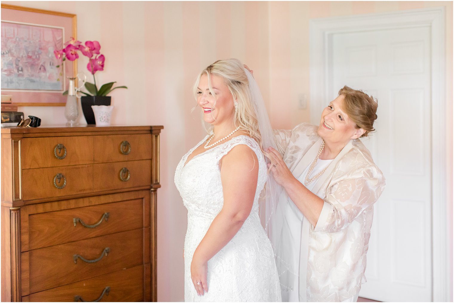 mother of the bride adjusts veil on morning of NJ wedding