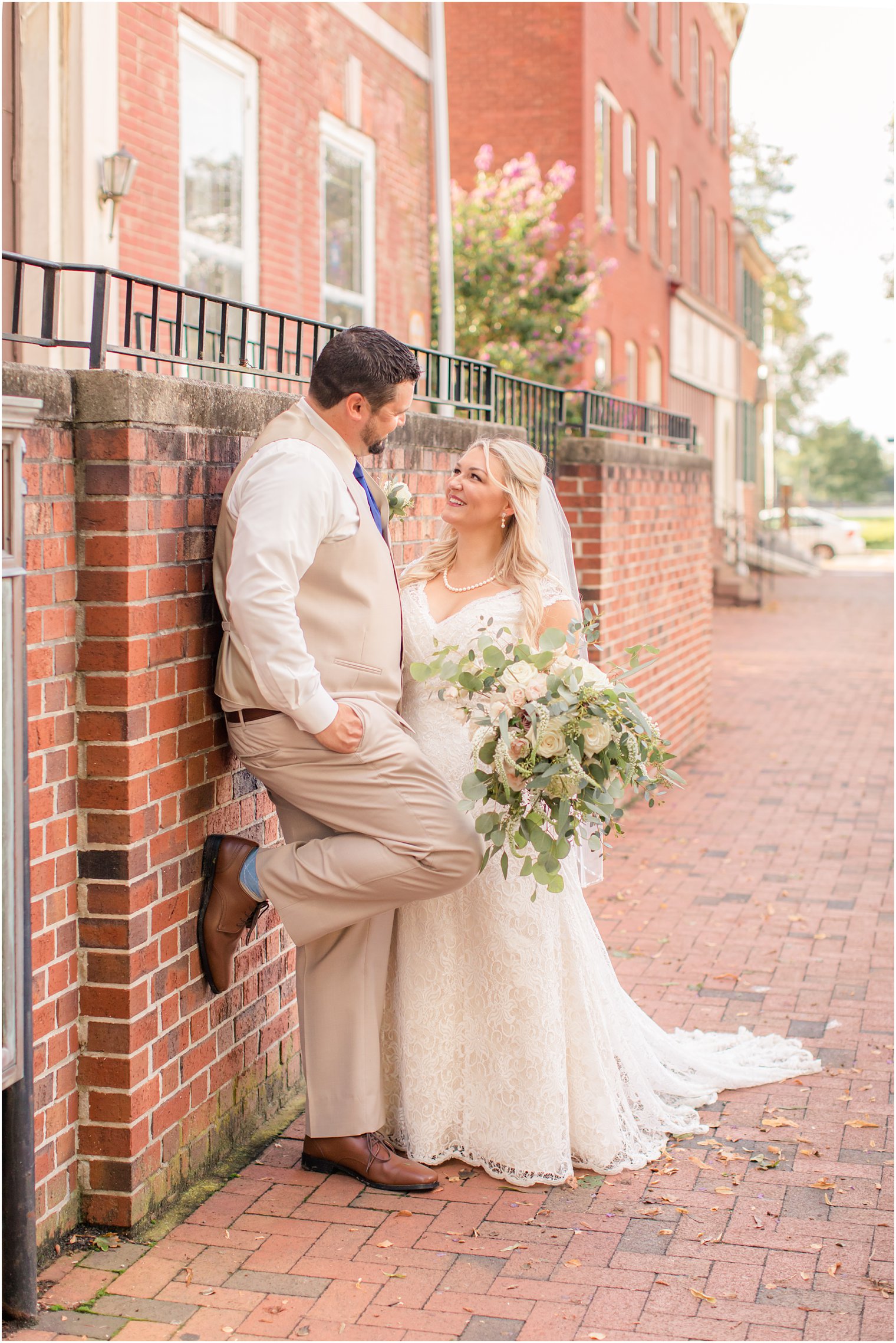 bride and groom pose on street in Burlington NJ