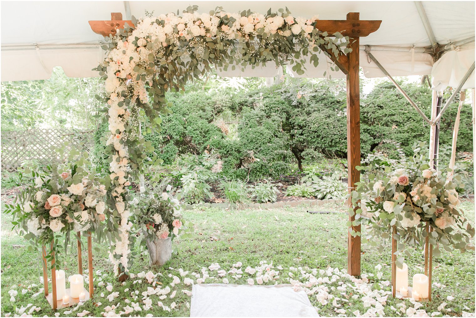 white flowers cover wooden arbor at The Lily Inn