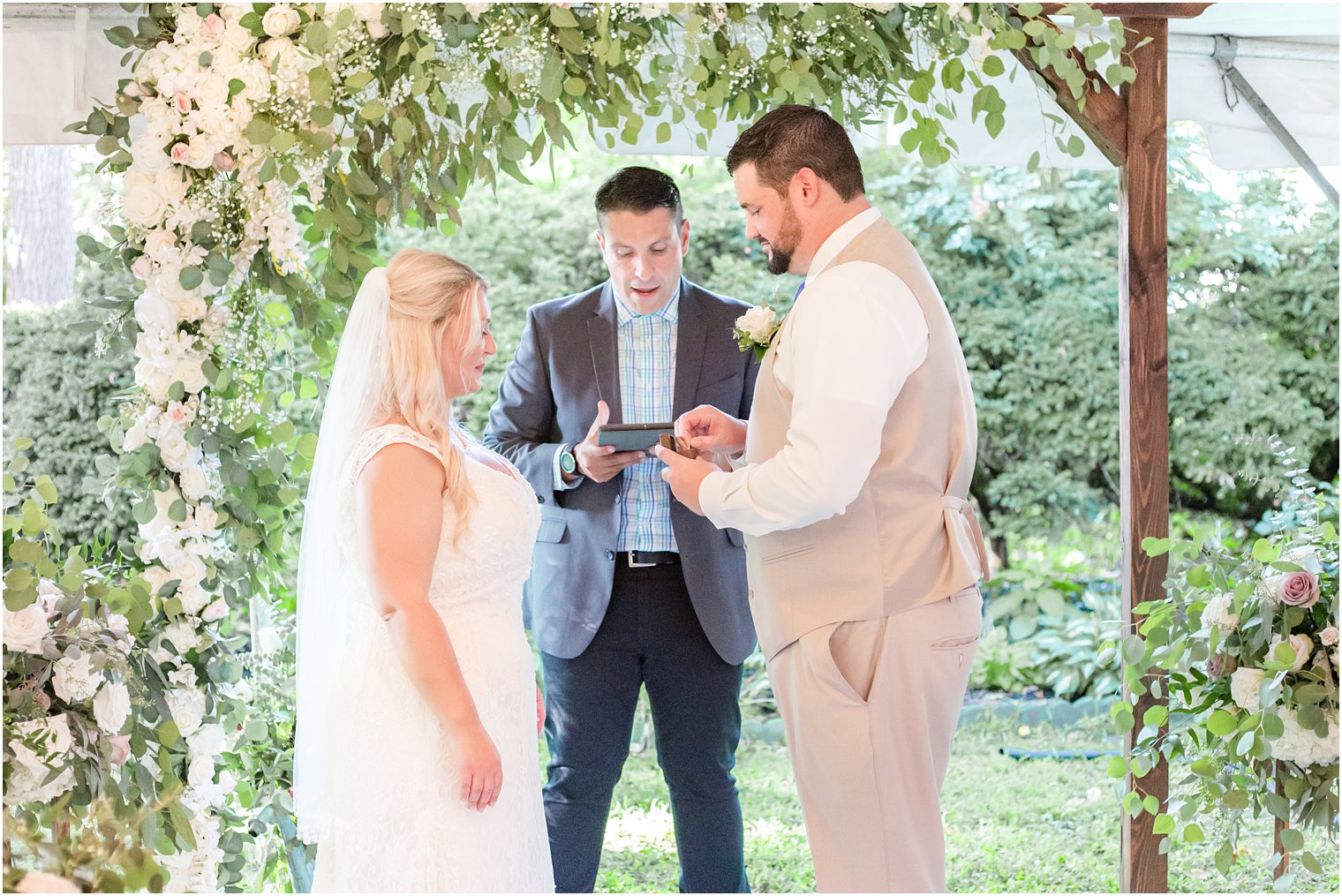 Micro Wedding ceremony at The Lily Inn under floral draped arbor