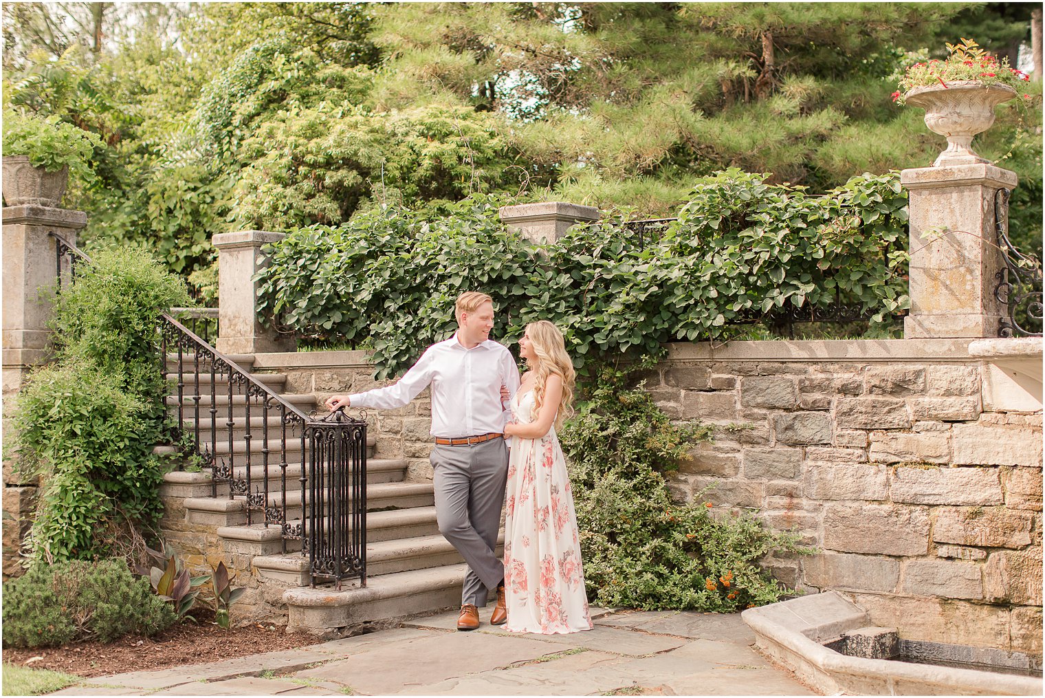 bride and groom pose by staircase in Ringwood NJ wedding venue