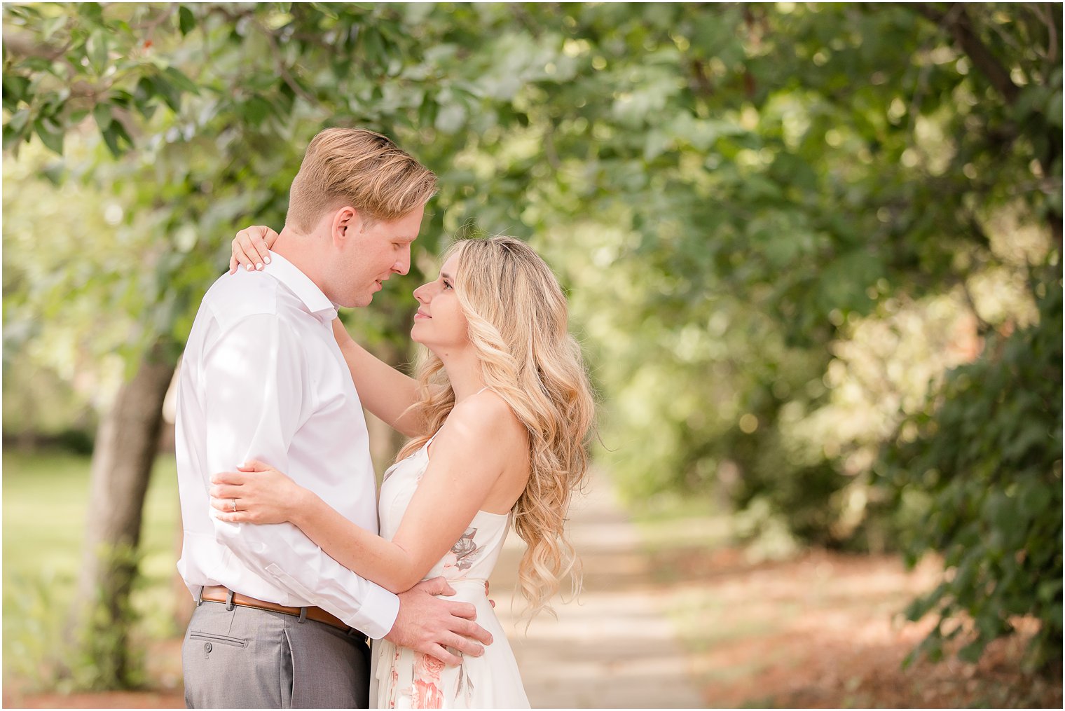 engaged couple stands nose to nose during Skylands Manor Engagement Session