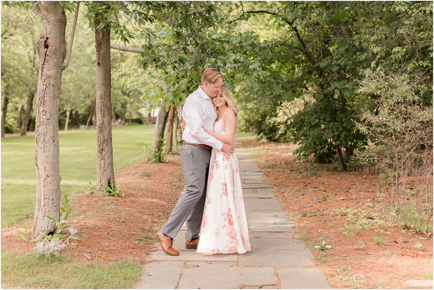 bride and groom hug on walkway in Ringwood NJ