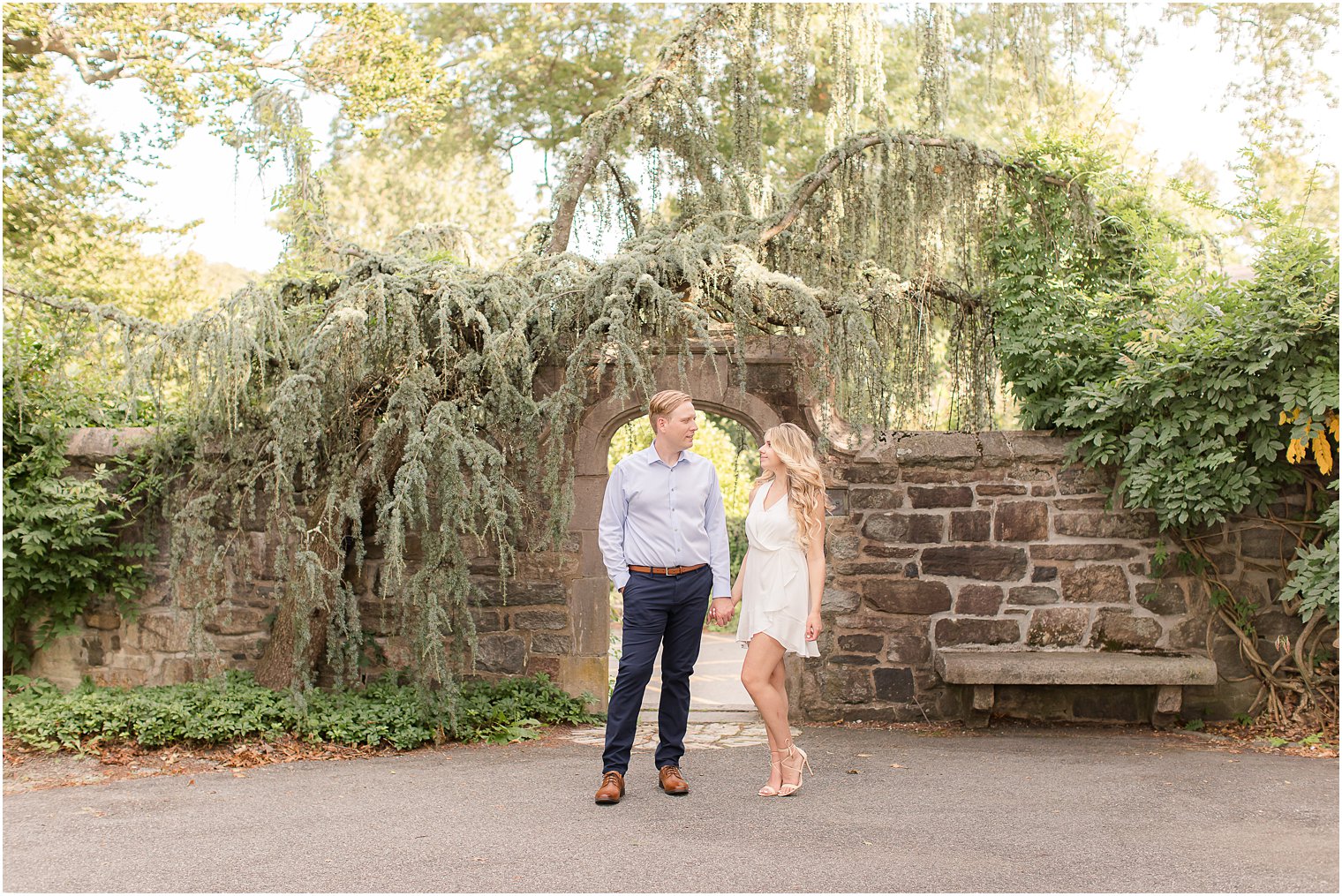 couple poses in front of stone walkway at Skylands Manor