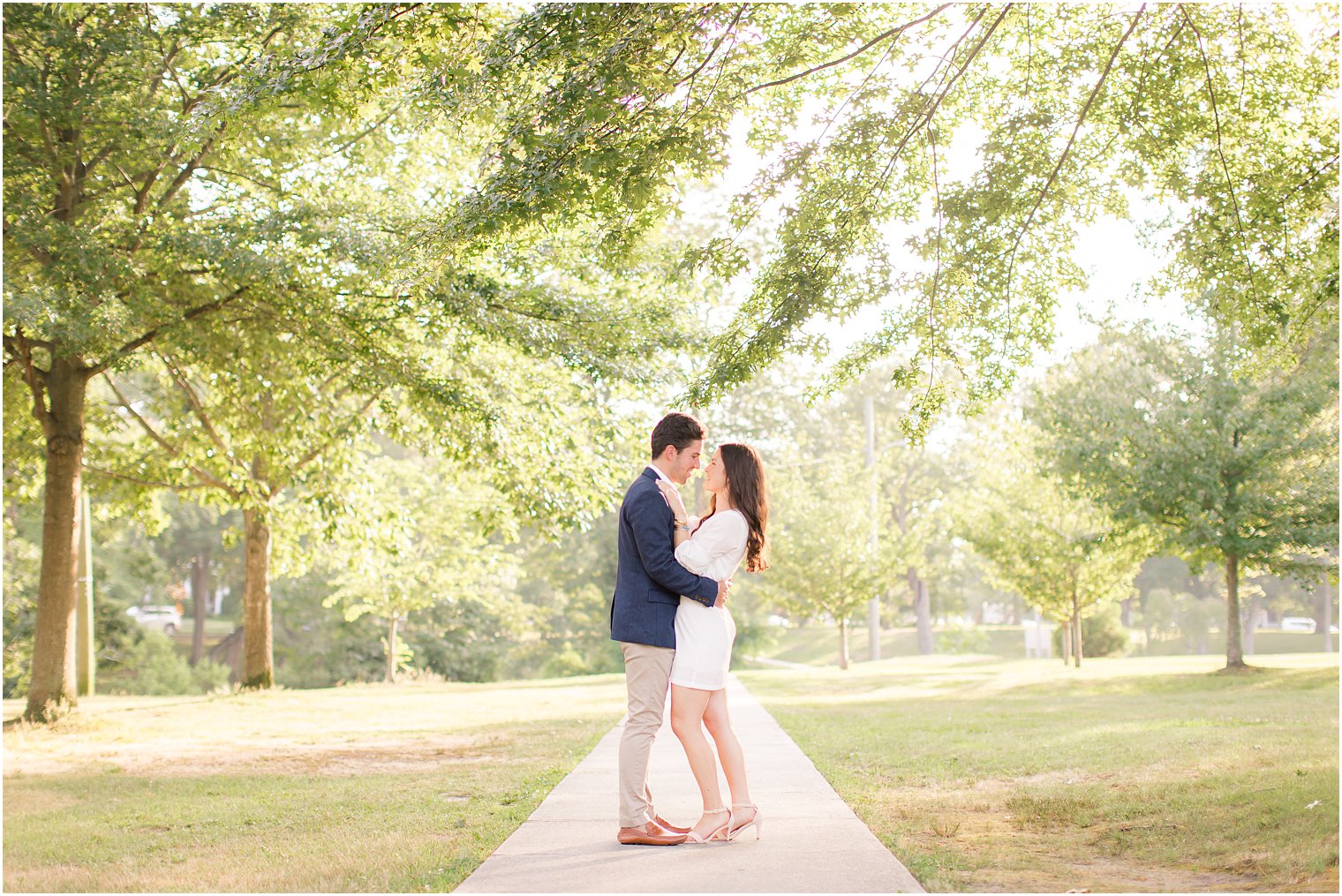 bride and groom face each other hugging during Spring Lake NJ engagement session