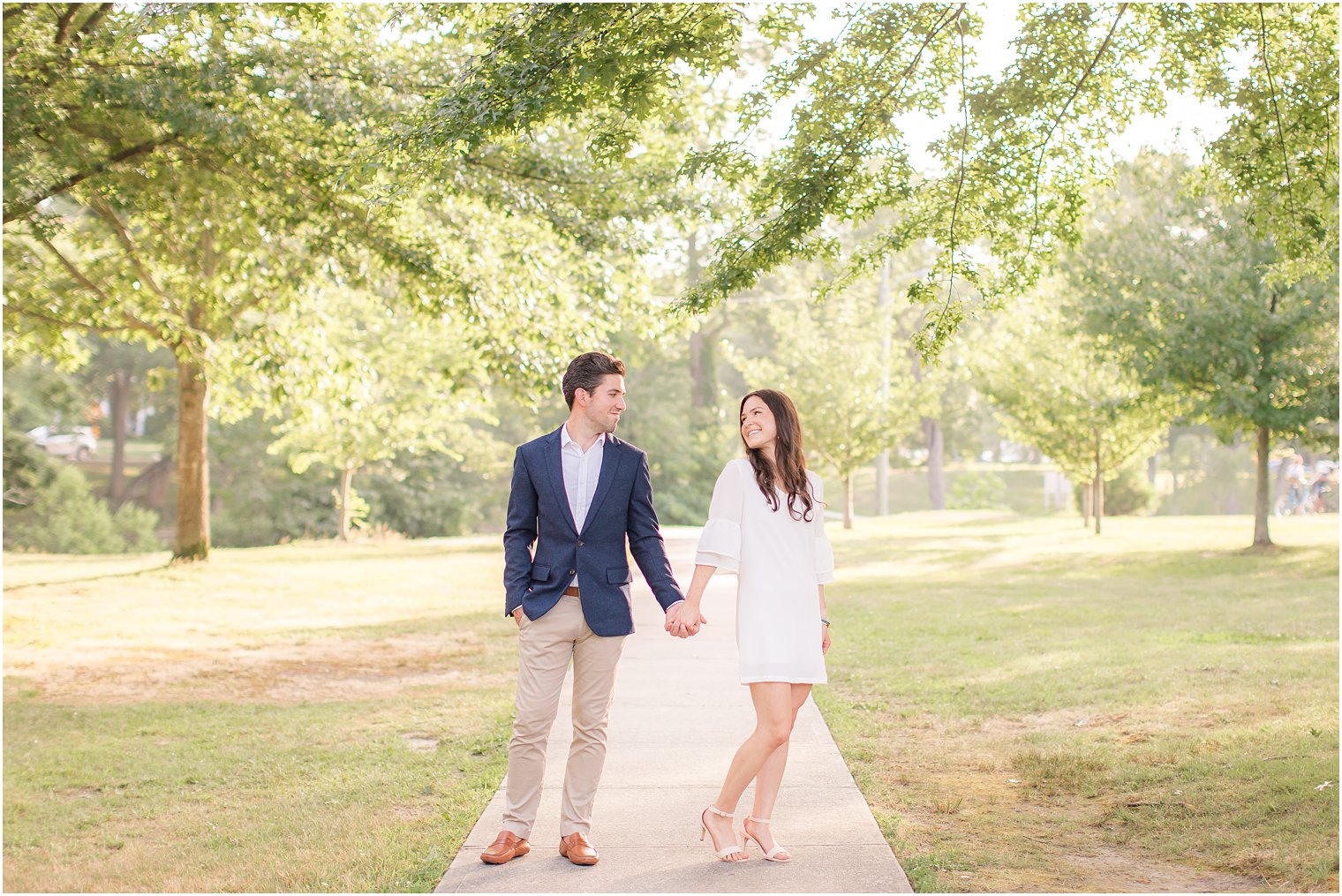 engaged couple holds hands in Spring Lake NJ park