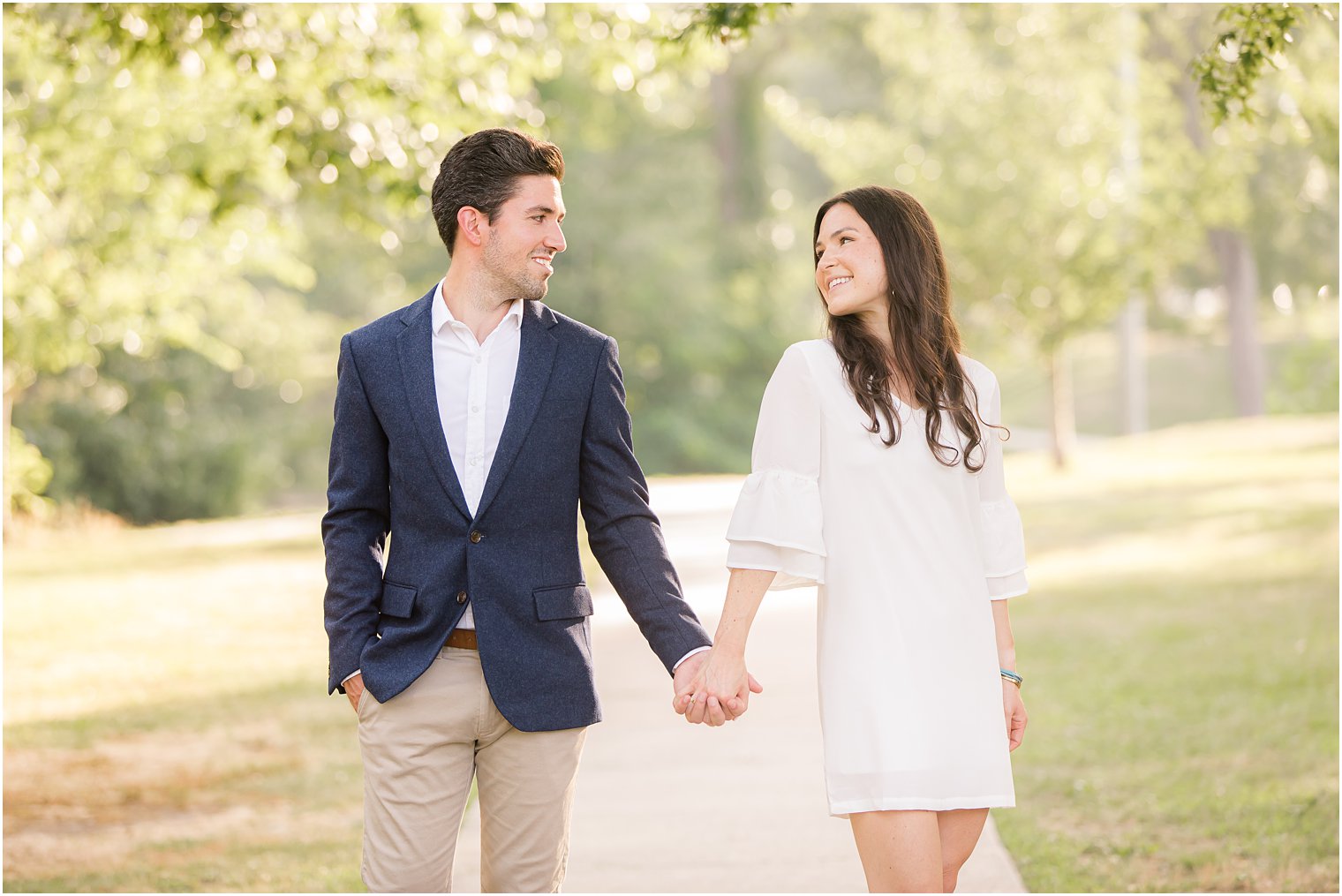 engaged couple holds hands and looks at each other during NJ engagement session