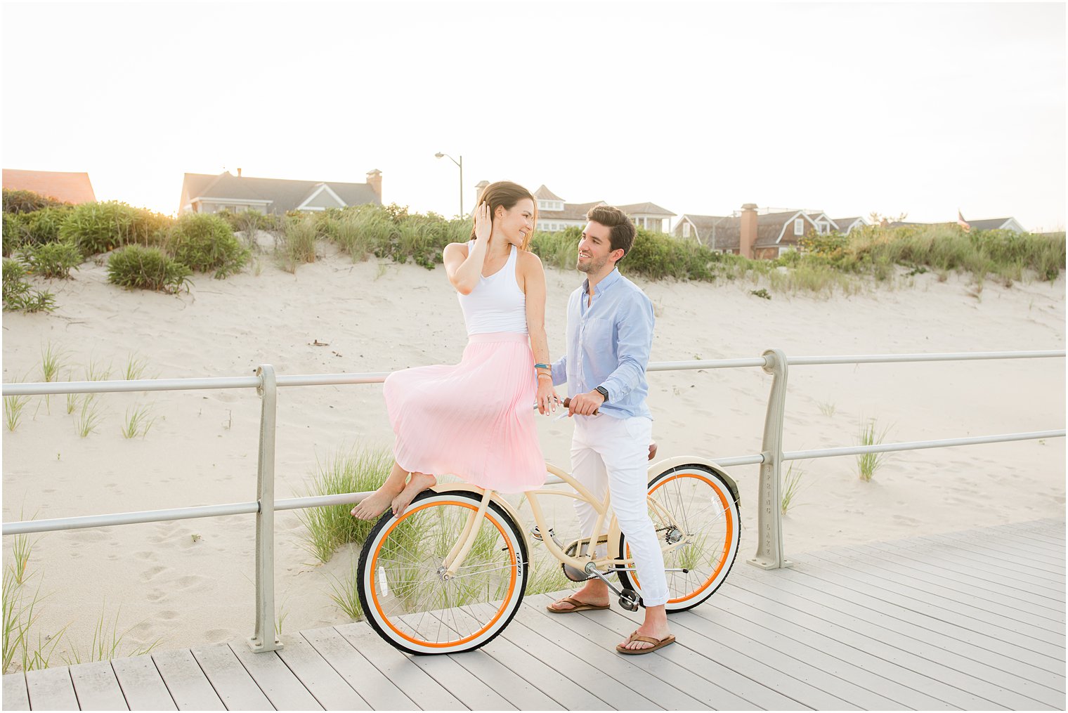 bride sits on handlebars of bike during NJ engagement portraits
