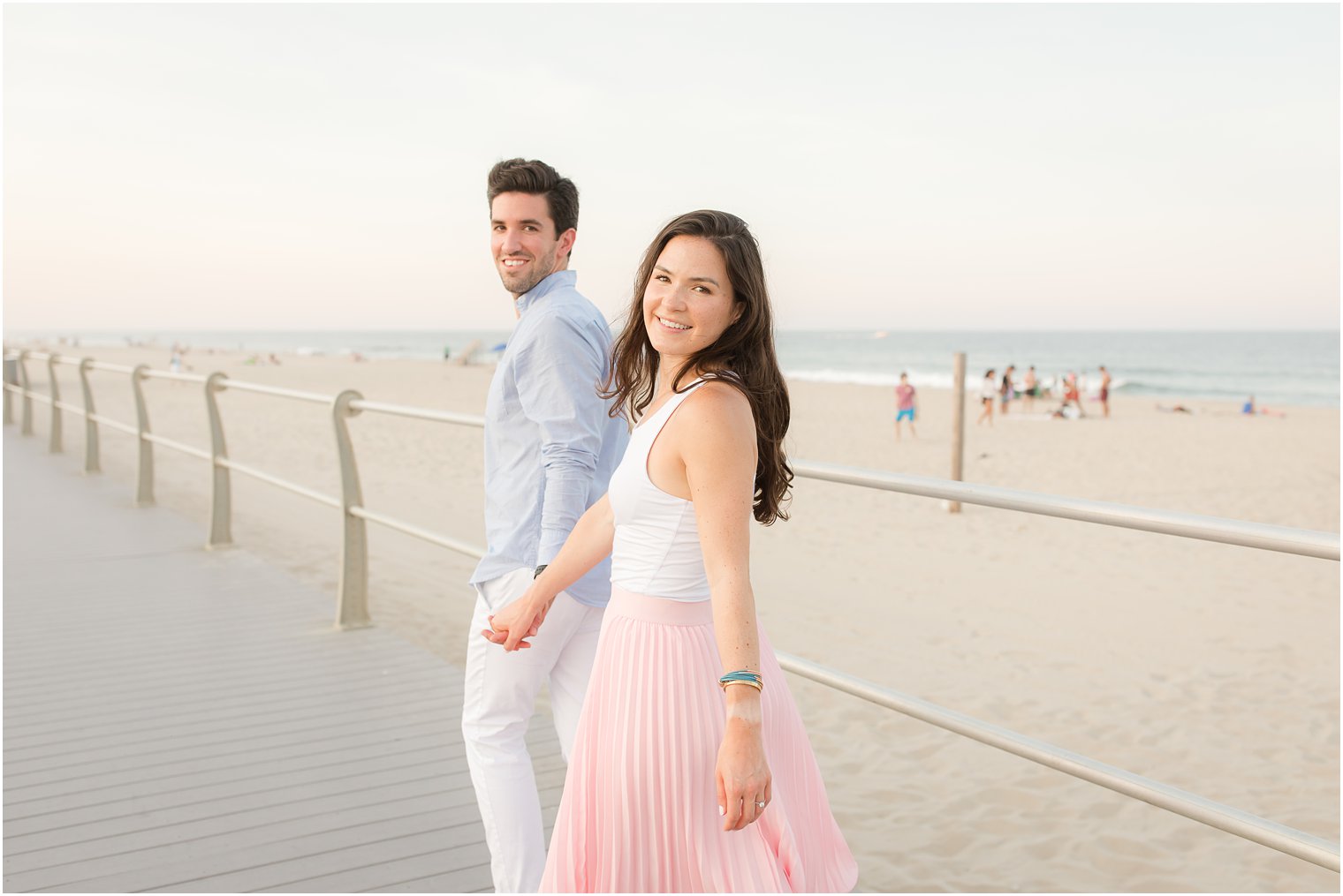Spring Lake NJ Engagement Session with pastel outfits on boardwalk