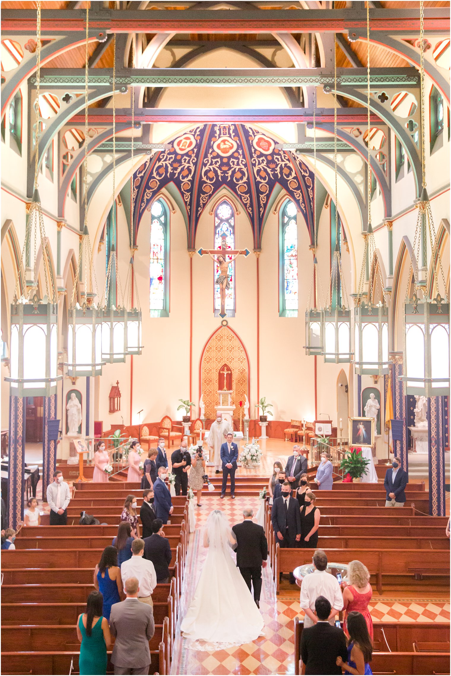 Balcony view of bride walking down the aisle with her father at Church of the Assumption in Morristown, NJ