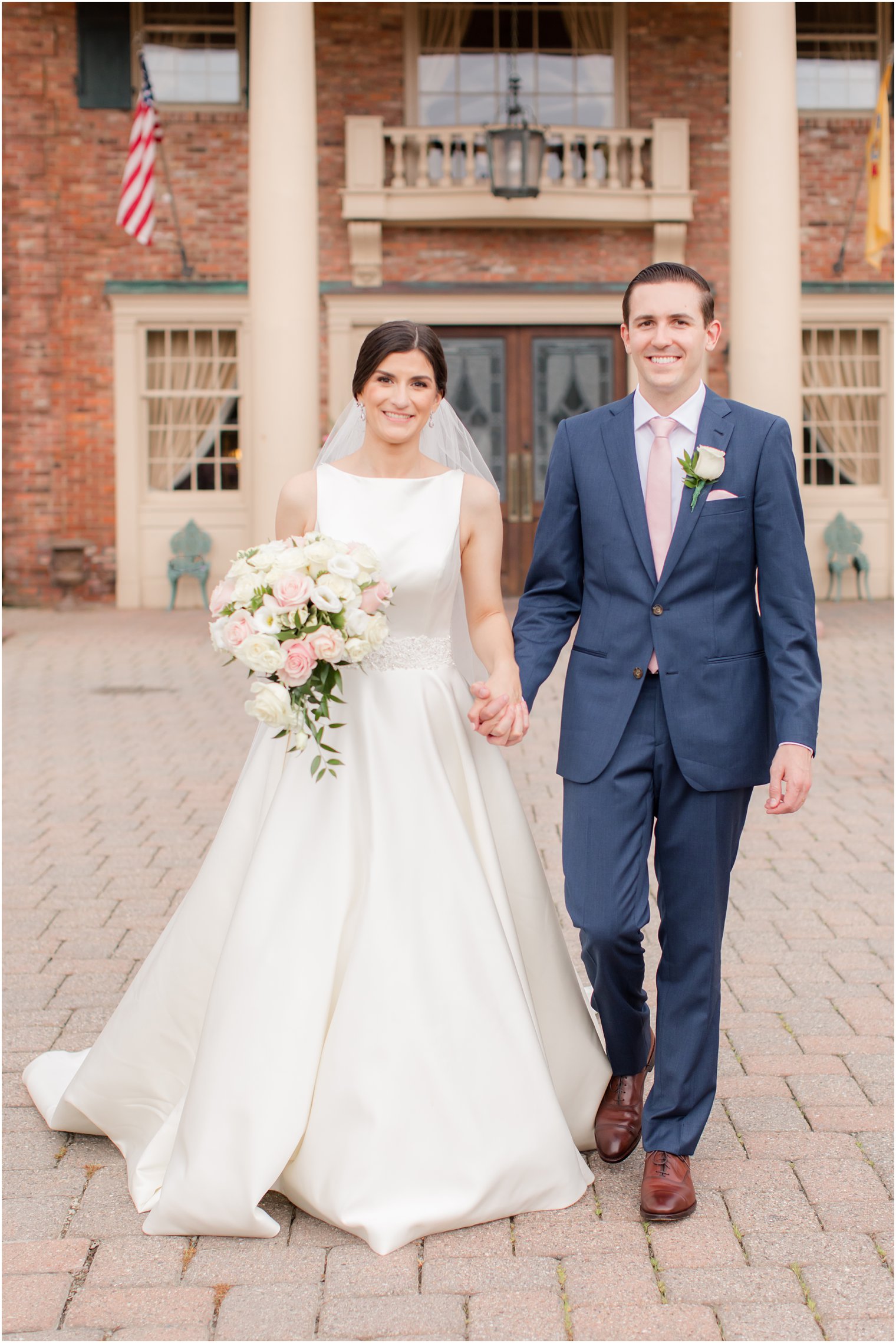 Candid photo of bride and groom walking at The Manor in West Orange NJ