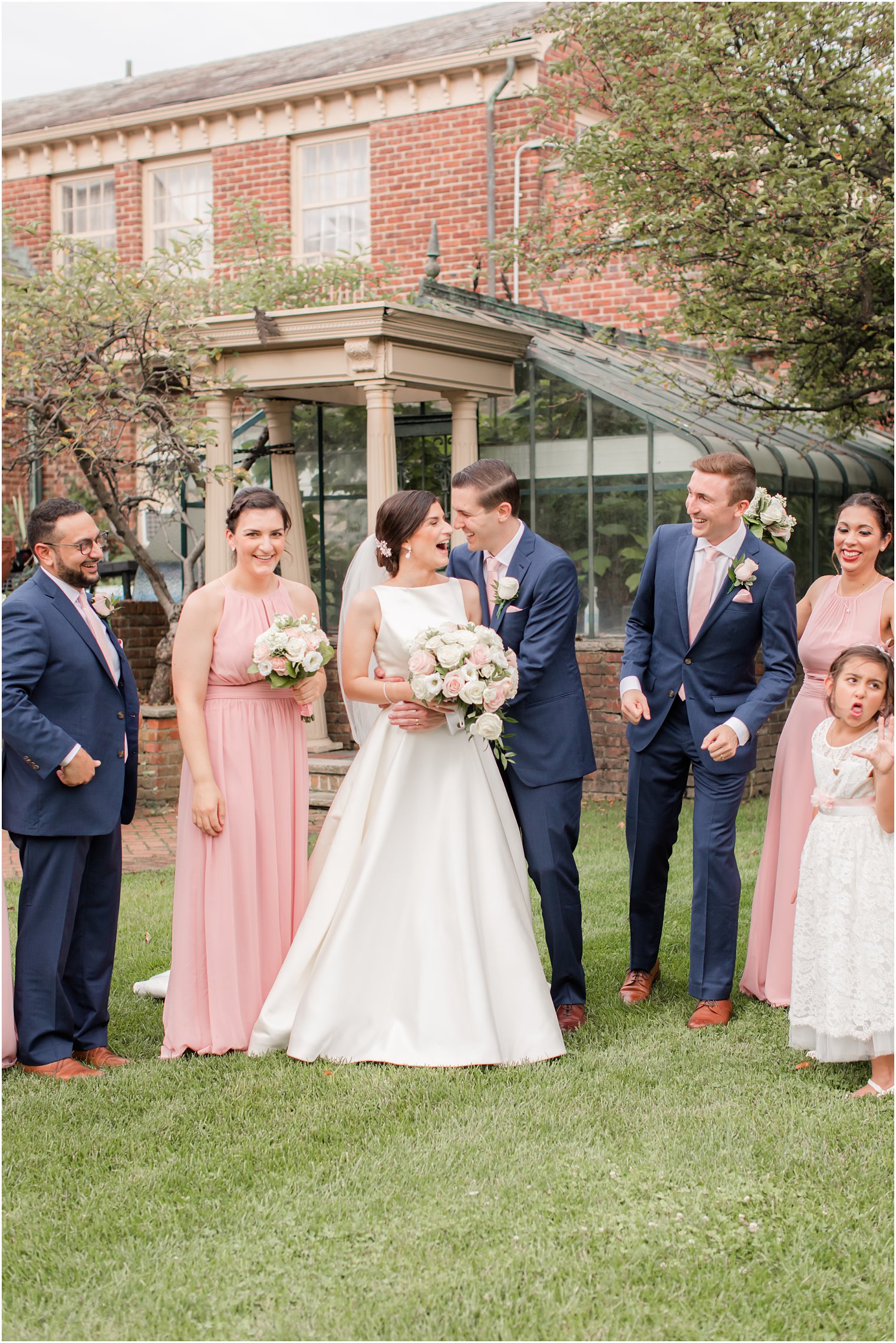 Candid photo of bride and groom with bridal party