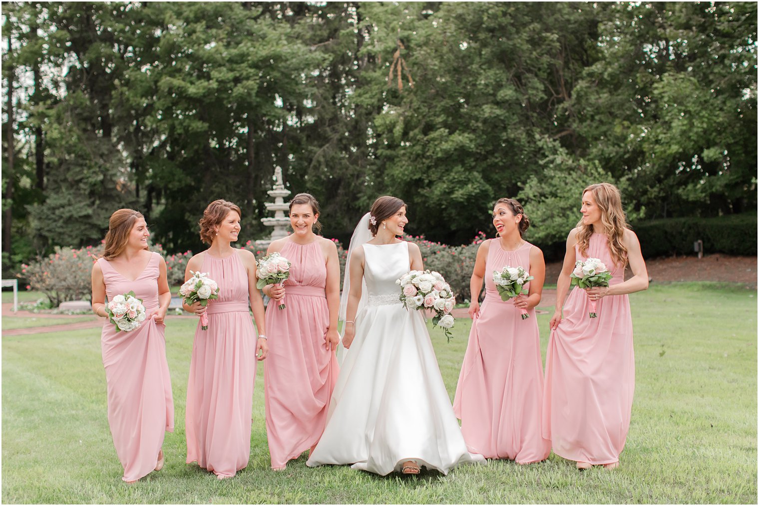 Candid photo of bridesmaids in pink dresses