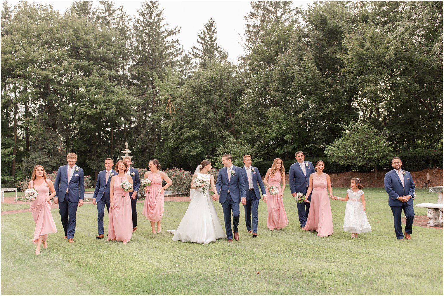 Candid photo of bridal party walking on the grounds of The Manor in West Orange NJ