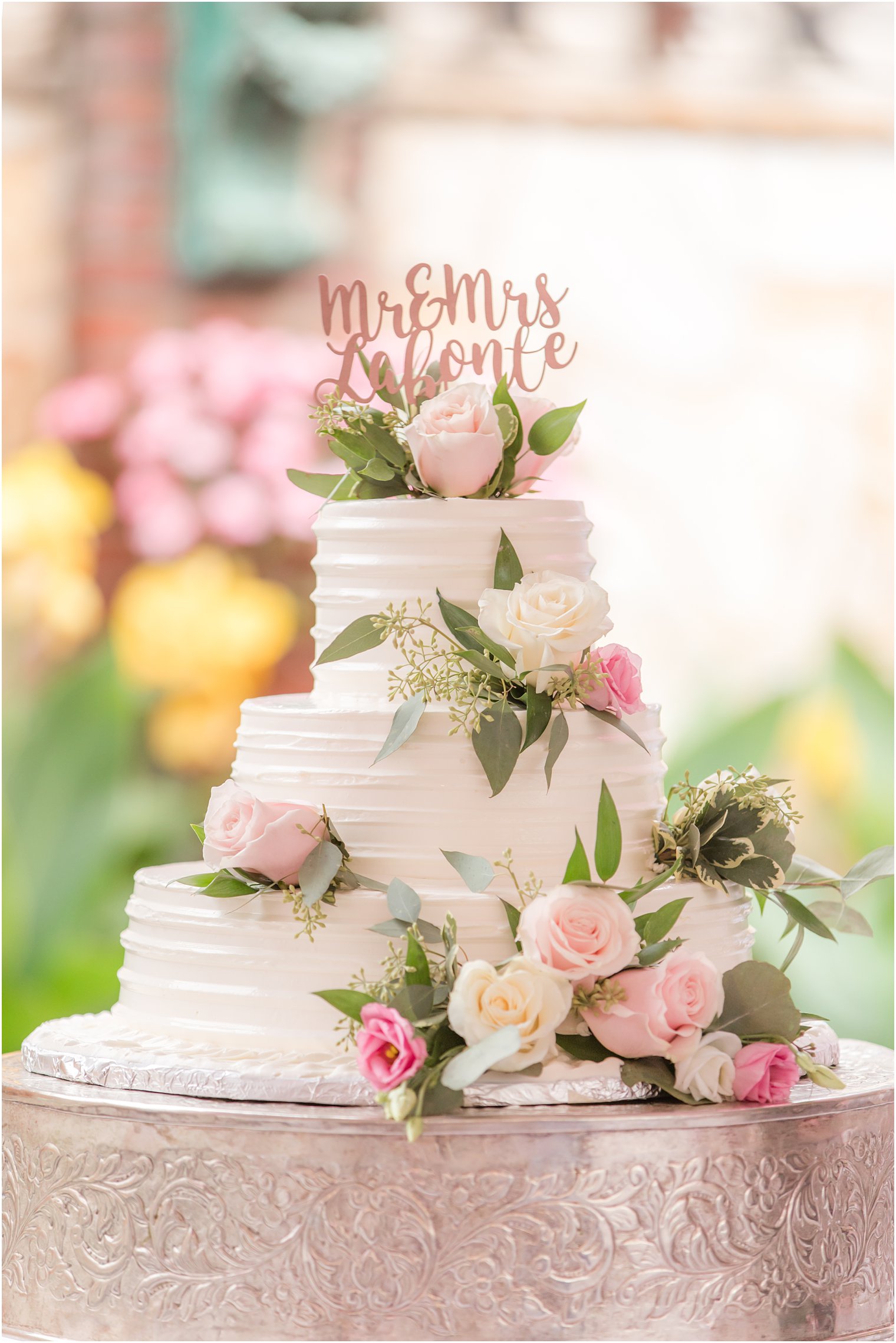 Wedding cake with florals by The Manor