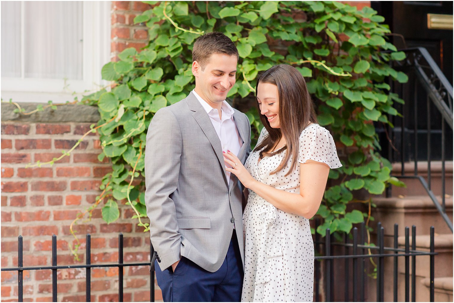 engaged couple looks at bride's ring during West Village Engagement Photos